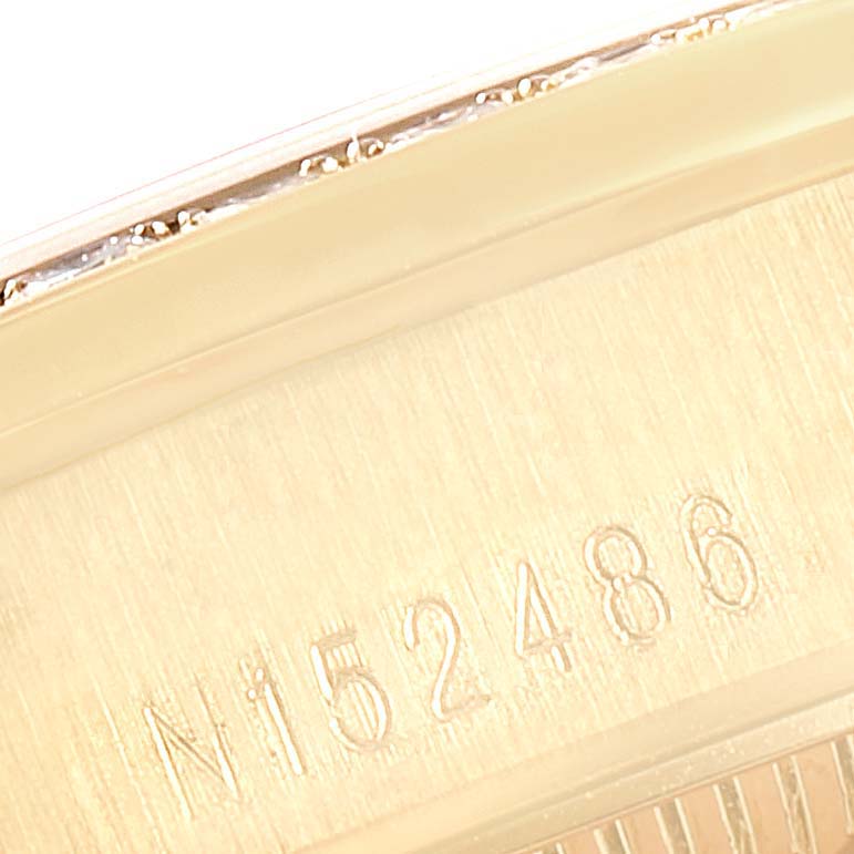 This image shows a close-up of the serial number engraved on the side of a Rolex President 68158 Women's Yellow Gold Grey Dial 68158 Women's Yellow Gold Grey Dial watch.