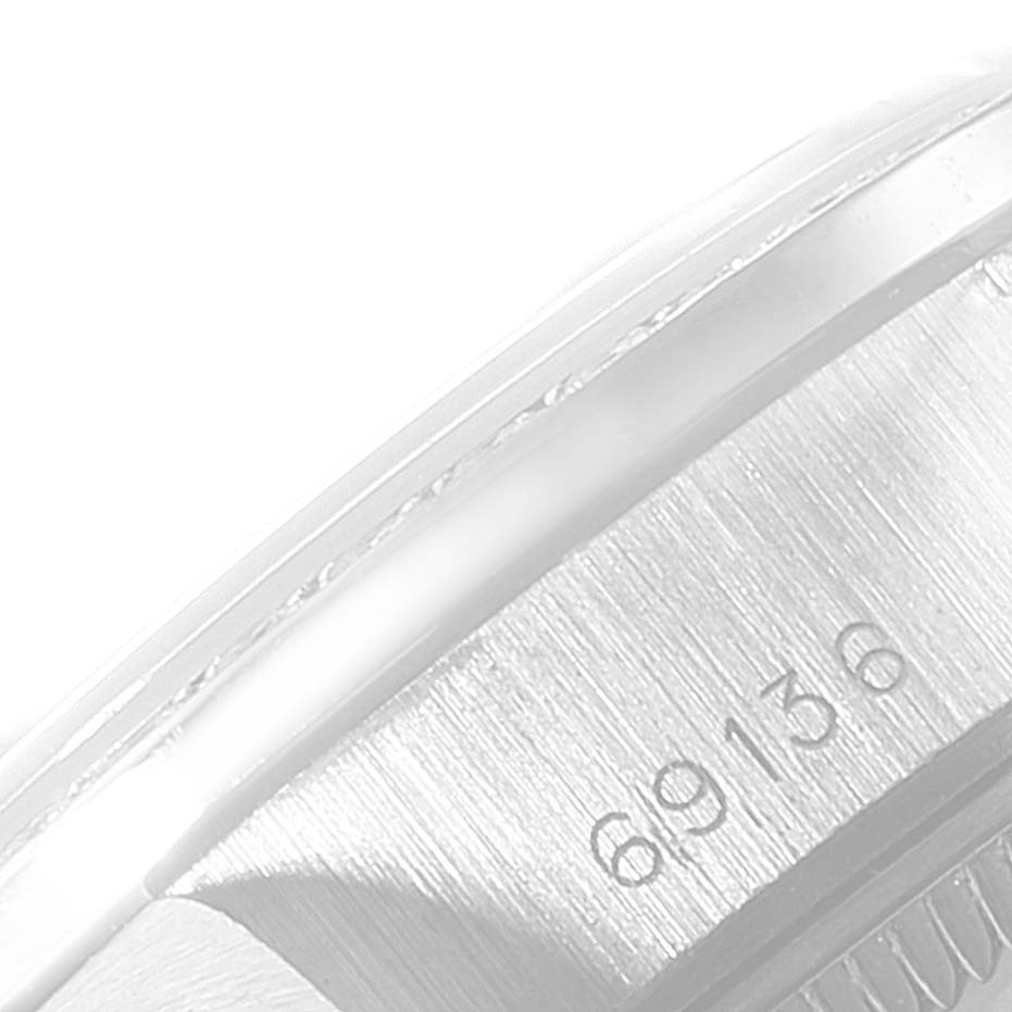 This image shows a close-up of the Rolex President 69136 Women's Platinum Silver Dial 69136 Women's Platinum Silver Dial model watch, featuring part of the case and the engraved serial number "69136".