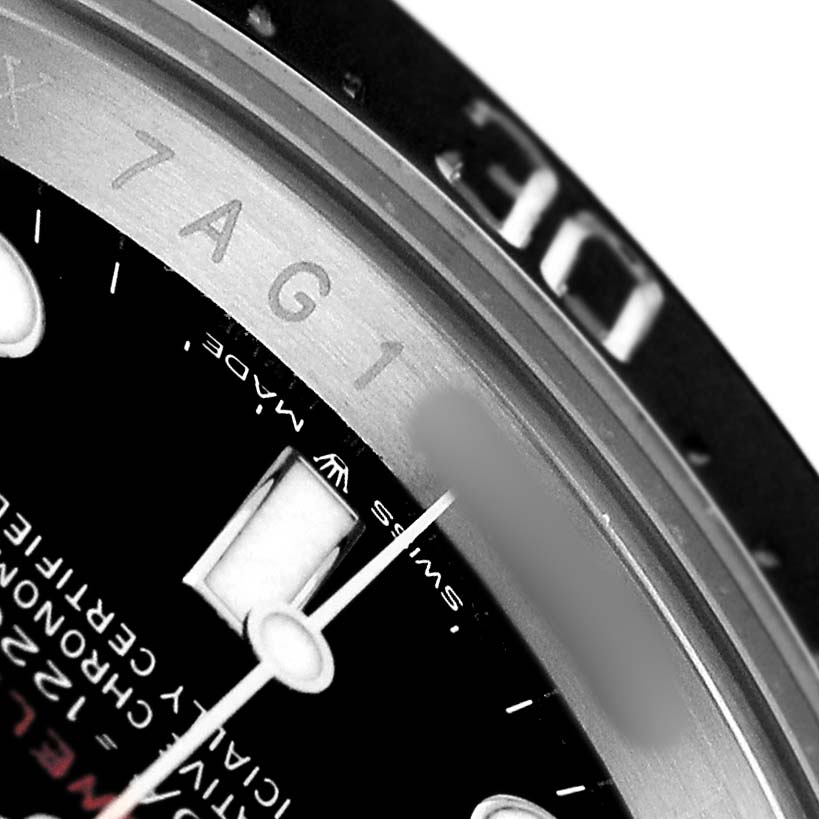 This close-up image of a Rolex Sea-Dweller 126600 Men's Stainless Steel Black Dial watch shows part of the dial, bezel, and engraved inner ring.