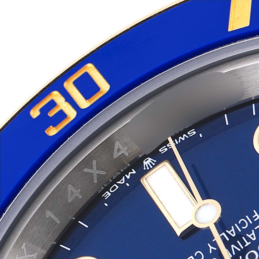 This close-up image of a Rolex Submariner 126613 Men
s Steel and Gold (two tone) Blue Dial 126613 Men
s Steel and Gold (two tone) Blue Dial watch shows part of the blue bezel with the number "30" and a portion of the dial.
