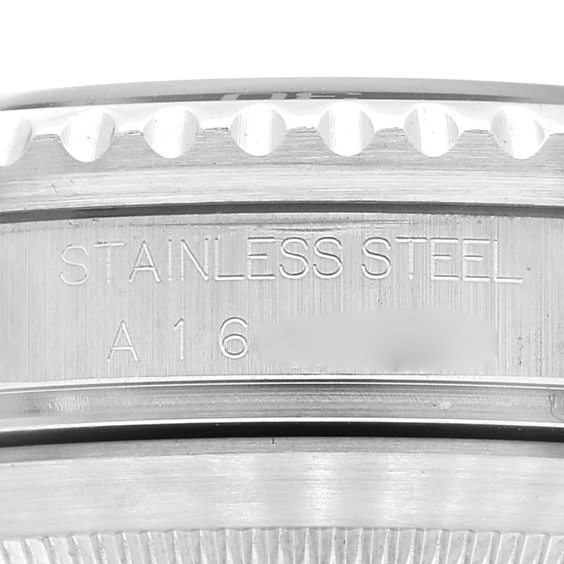 This image shows a close-up of the side of the case back and bezel of the Rolex Submariner 16610 Men
s Stainless Steel Black Dial 16610 Men
s Stainless Steel Black Dial, highlighting "STAINLESS STEEL" engraving.