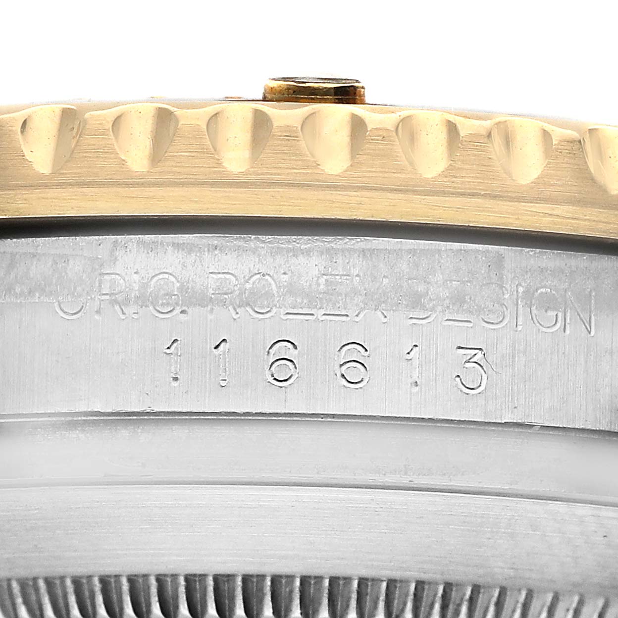 The image shows a close-up of the side of a Rolex Submariner 116613 Men's Steel and Gold (two tone) Black Dial, highlighting the bezel and engraved model number.