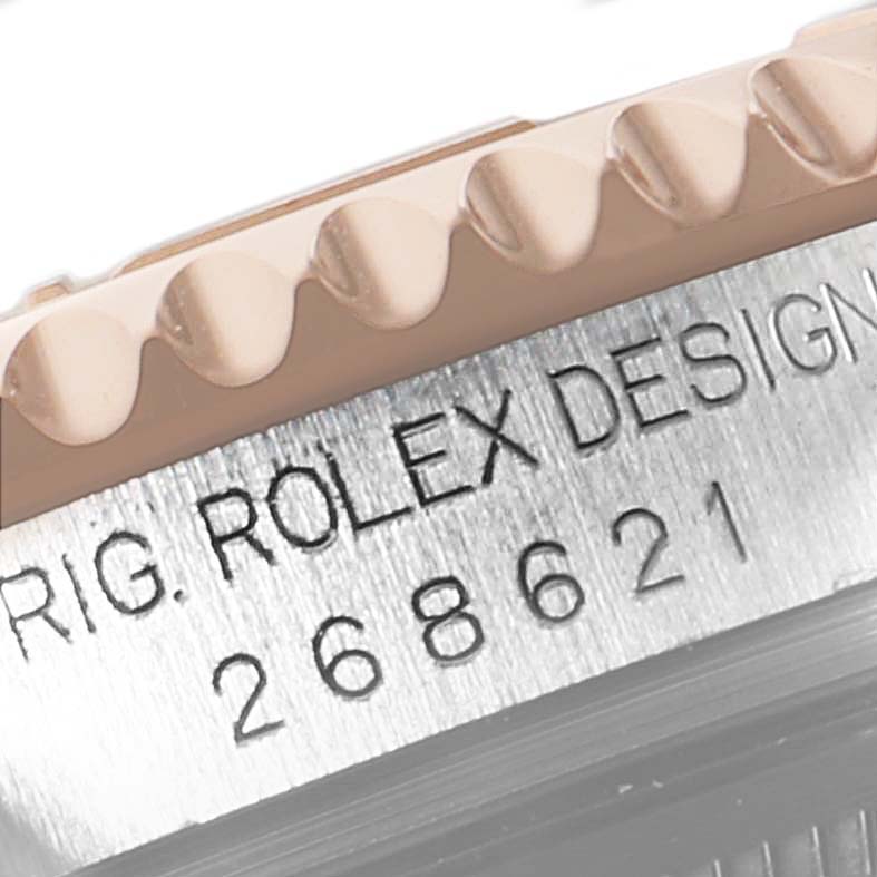 This close-up shows the side view of a Rolex Yacht-Master 268621 Men's Steel and Gold (two tone) Brown Dial 268621 Men's Steel and Gold (two tone) Brown Dial's bezel and engraved serial number.