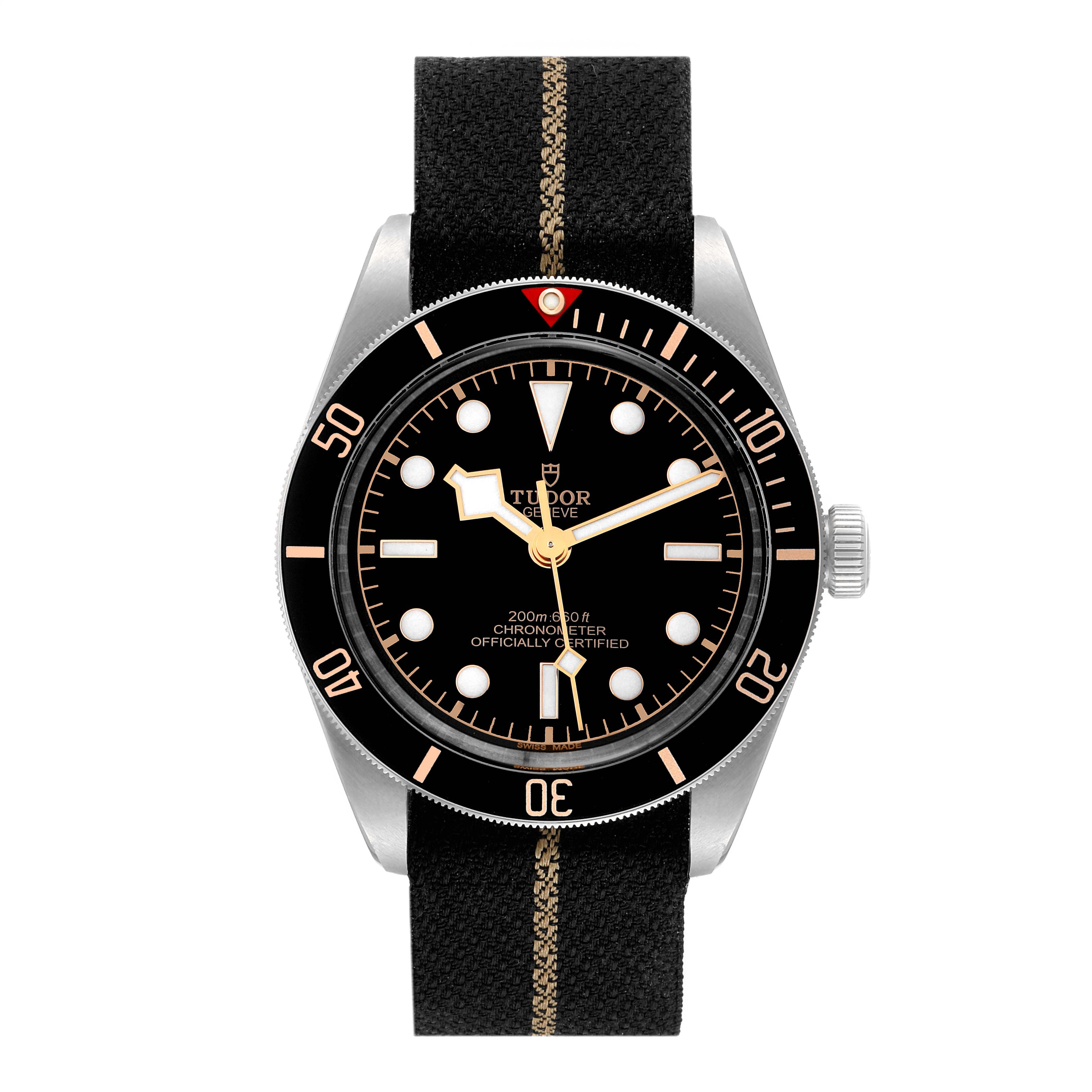 The image shows a front view of the Tudor Heritage Black Bay 79030N Men
s Stainless Steel Black Dial 79030N Men
s Stainless Steel Black Dial watch with a black fabric strap and a black dial.