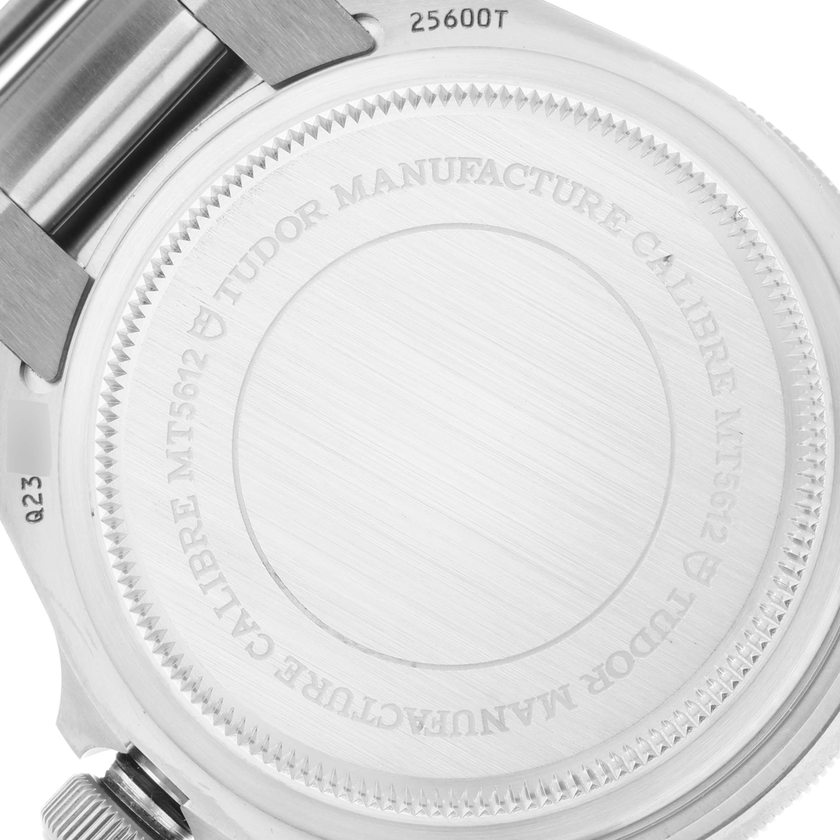 The image shows the case back of a Tudor Pelagos M25600TN-0001 Men's Titanium Black Dial M25600TN-0001 Men's Titanium Black Dial watch, highlighting the engraved details and serial number.