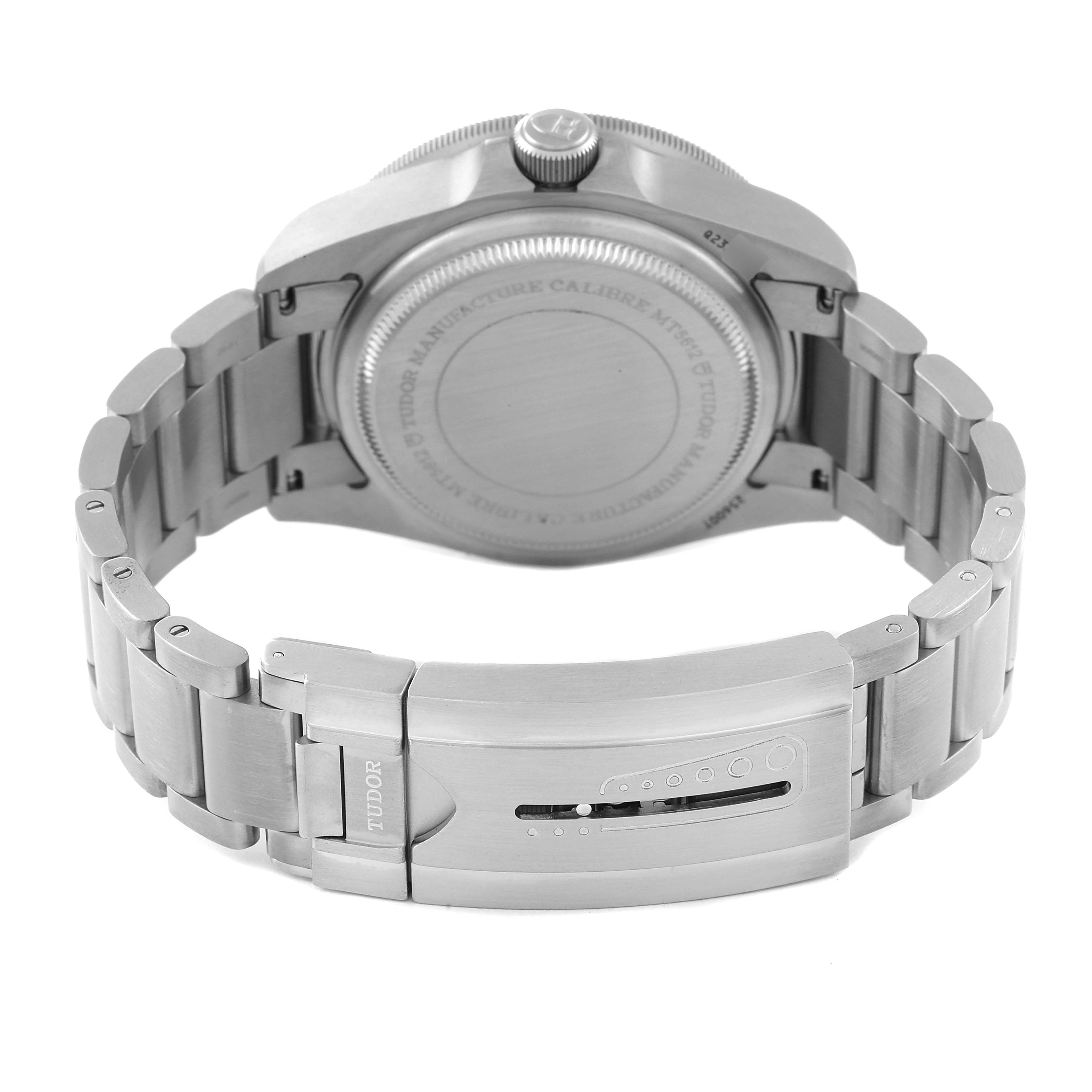 The image shows the back view of a Tudor Pelagos M25600TN-0001 Men's Titanium Black Dial M25600TN-0001 Men's Titanium Black Dial watch, highlighting the case back and the clasp of the metal bracelet.