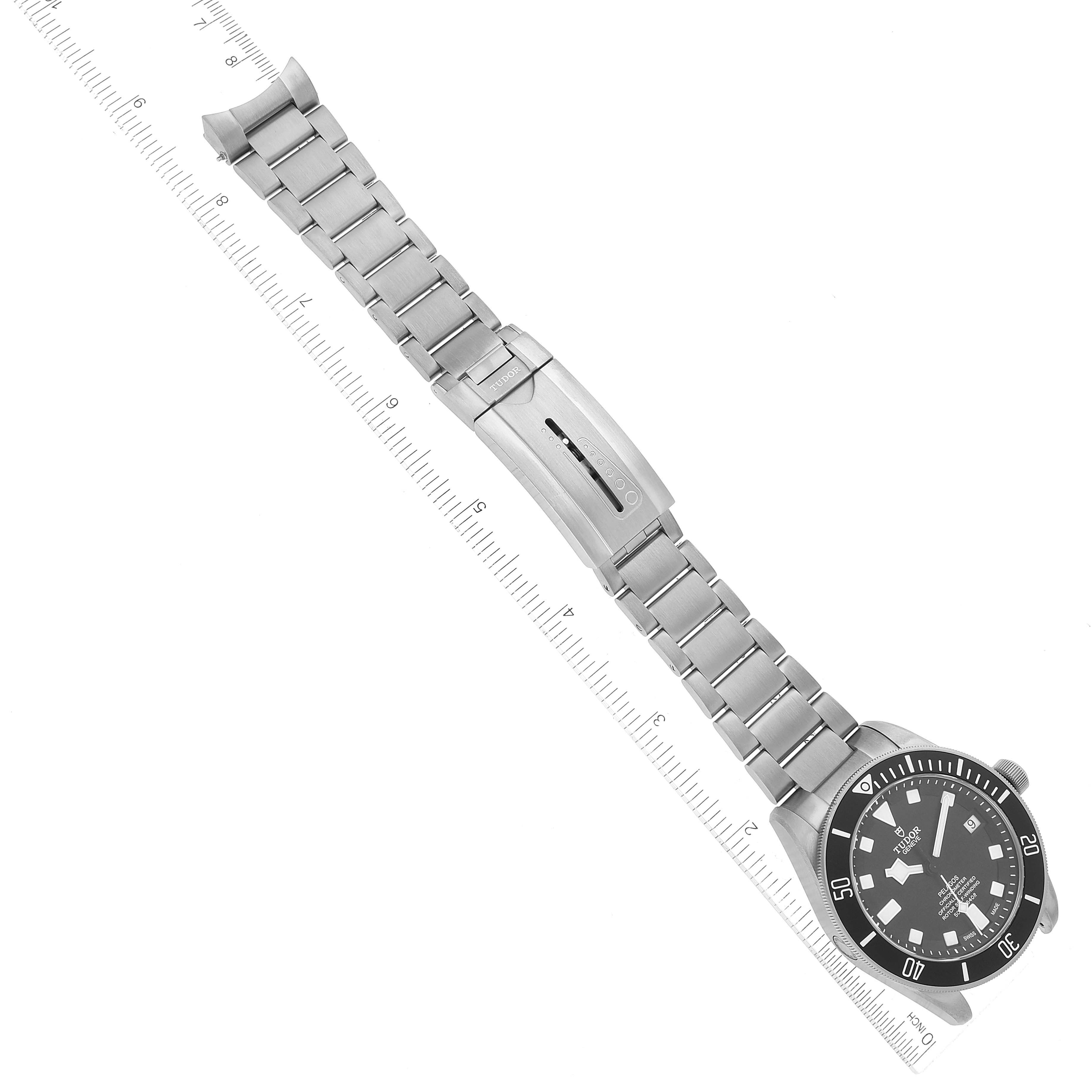 The image shows a top-down view of the Tudor Pelagos M25600TN-0001 Men's Titanium Black Dial M25600TN-0001 Men's Titanium Black Dial watch, focusing on its dial, bracelet, and clasp, with a ruler for scale.