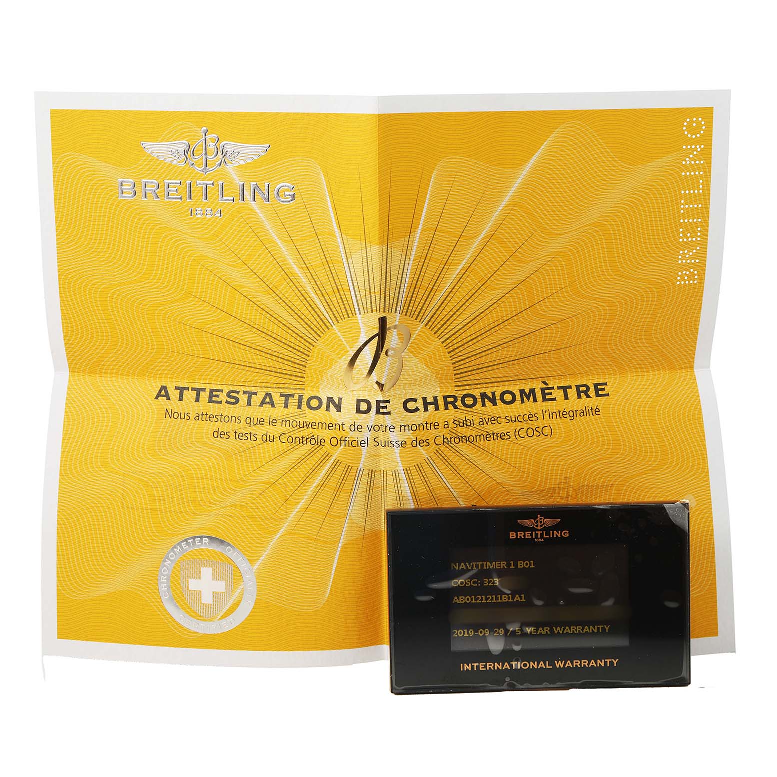This image shows a Breitling Navitimer AB0121 Men's Stainless Steel Black Dial certificate and warranty card, featuring brand logos and details.