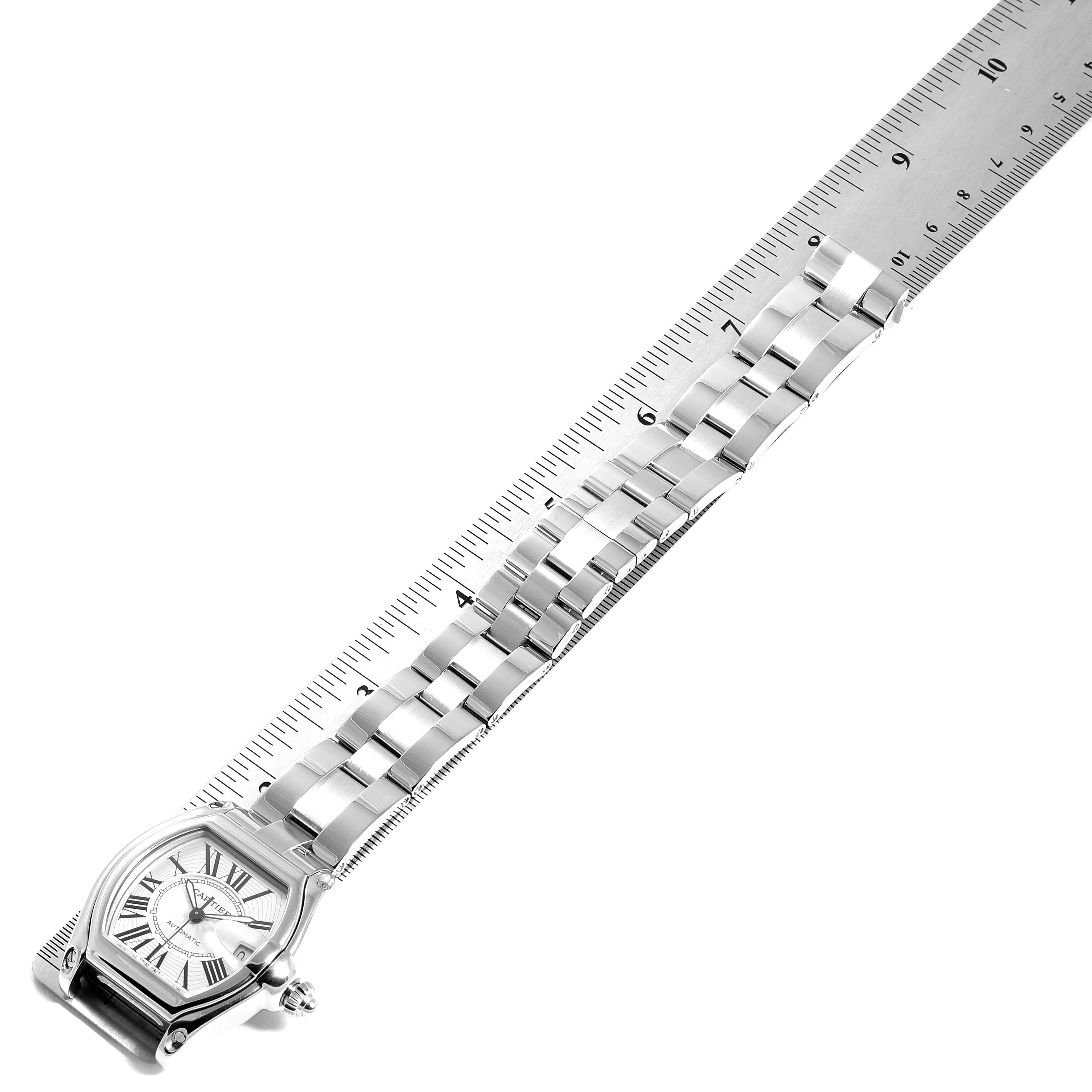 The image shows a Cartier Roadster W62025V3 Men's Stainless Steel Silver Dial W62025V3 Men's Stainless Steel Silver Dial watch face and stainless steel bracelet laid next to a ruler for measurement.