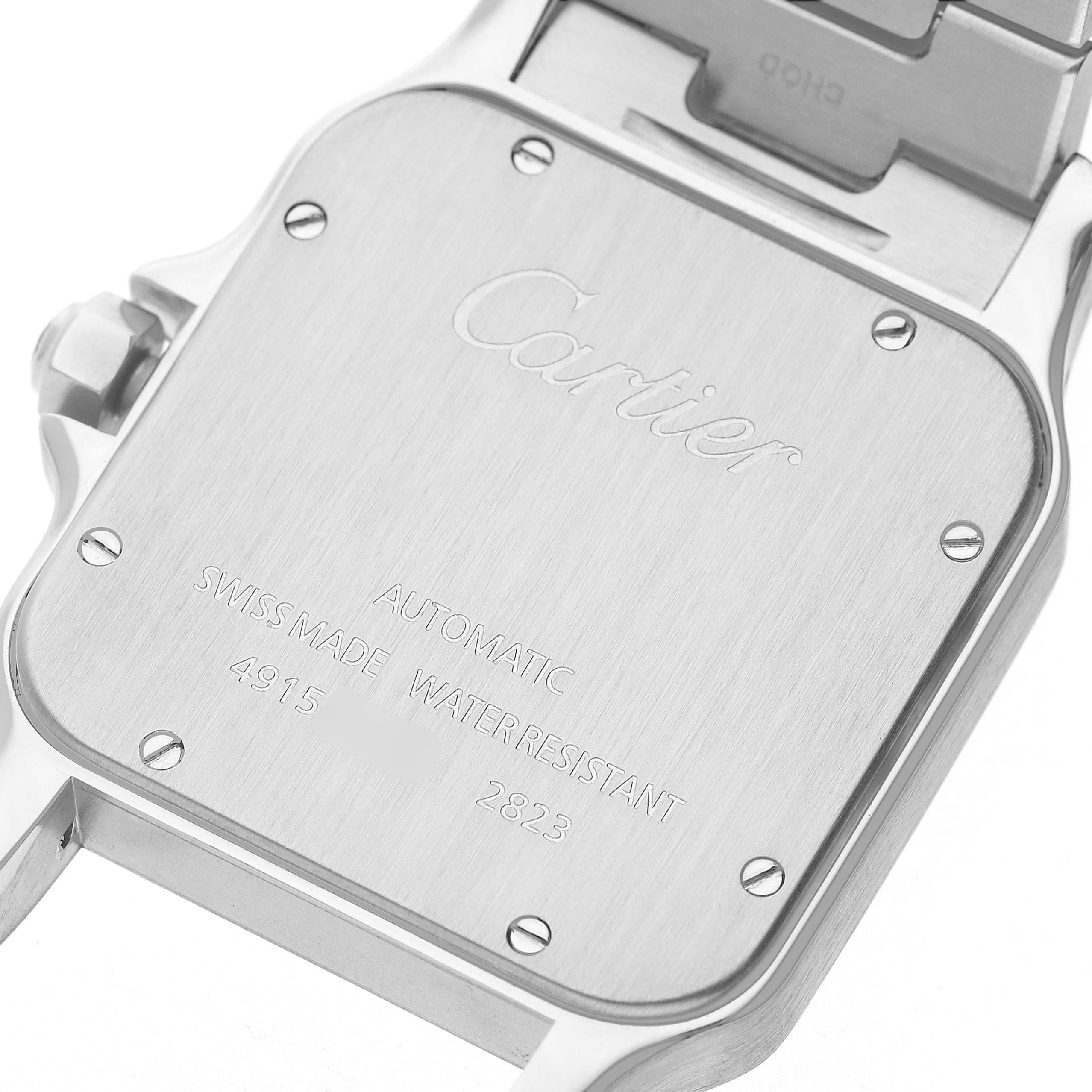 The image shows the back case of a Cartier Santos W20099C4 Men's Steel and Gold (two tone) Silver Dial watch, featuring engraved text and visible screws.