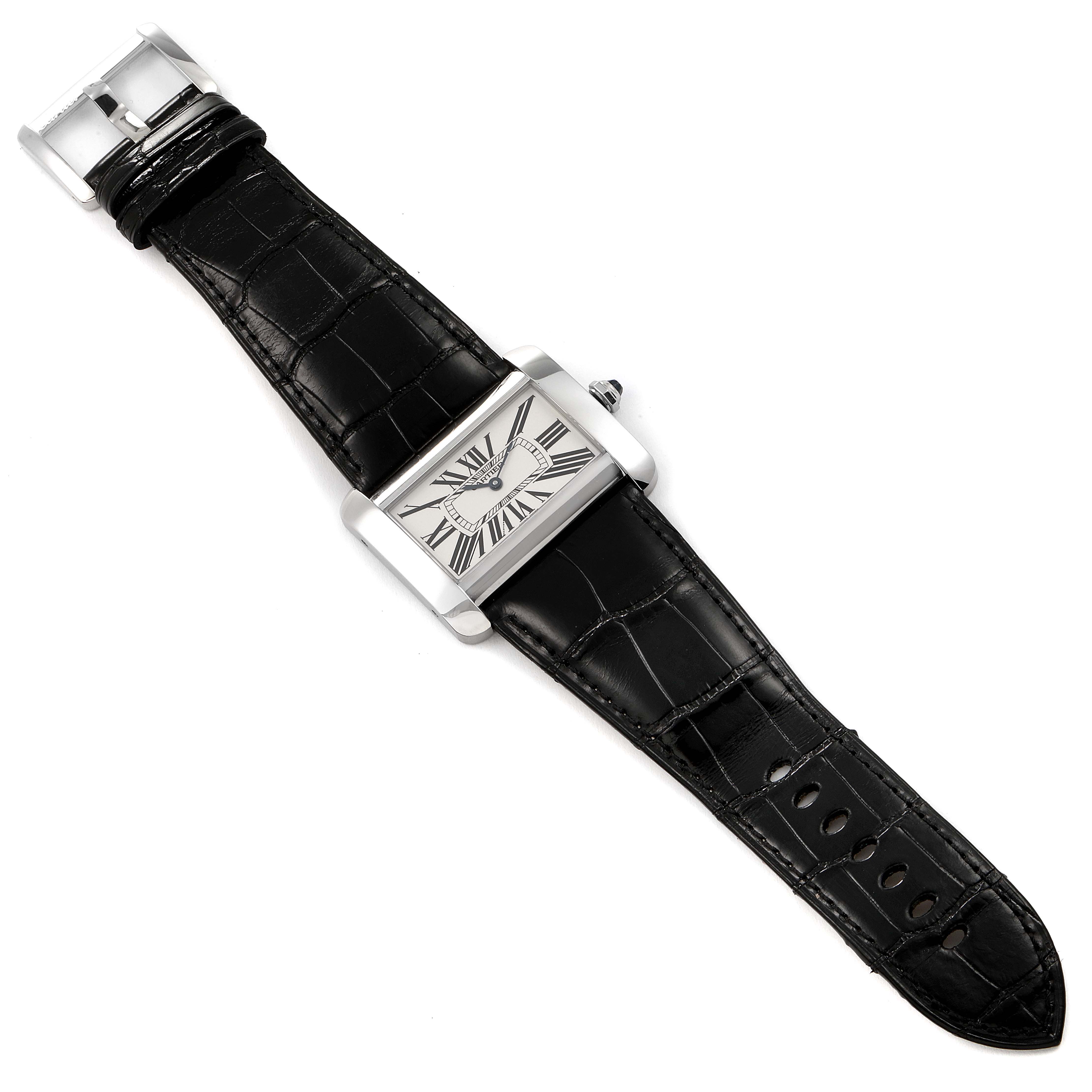 The image shows a top-down angle of a Cartier Tank Divan W6300755 Women
s Stainless Steel Silver Dial W6300755 Women
s Stainless Steel Silver Dial watch, showcasing its black leather strap and rectangular face with Roman numerals.