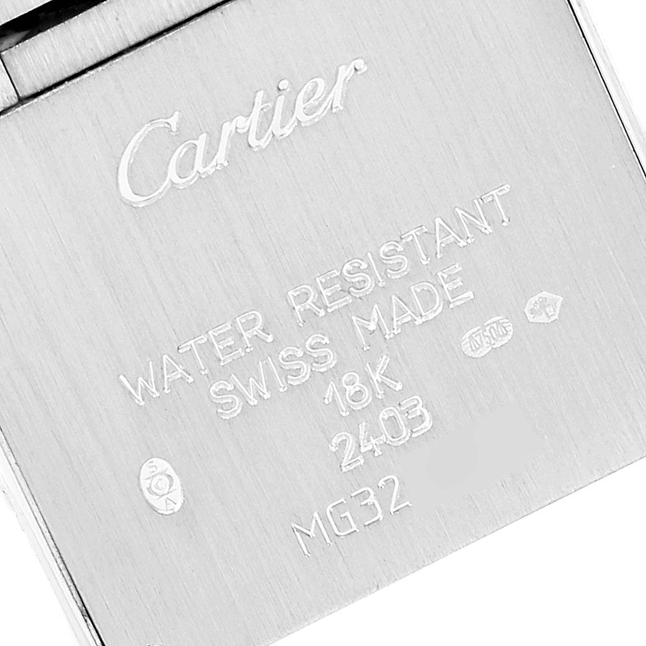 The image shows the back side of a Cartier Tank Francaise WE1002S3 Women's White Gold Silver Dial WE1002S3 Women's White Gold Silver Dial watch, highlighting the engraving and markings.