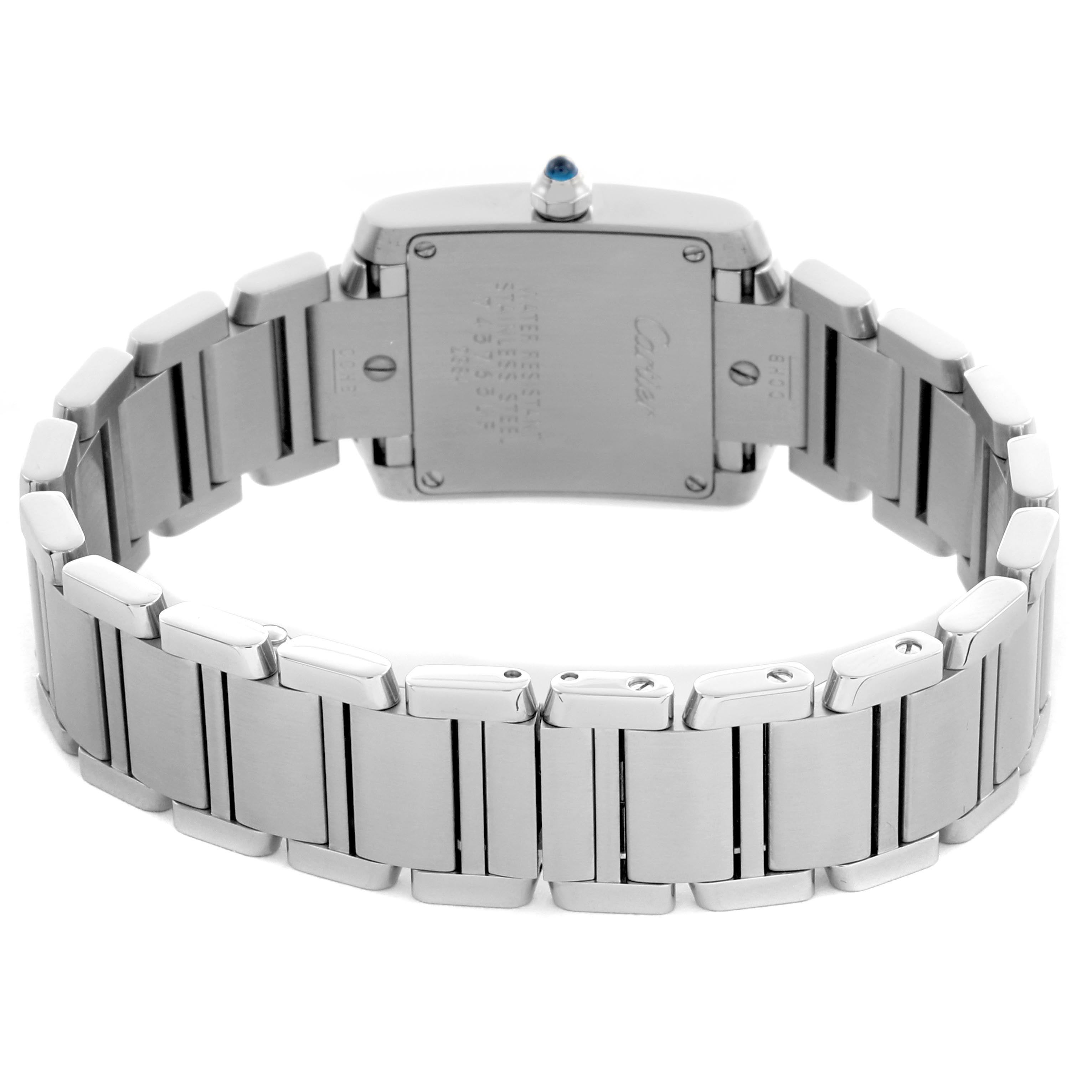 The image shows the back view of a Cartier Tank Française model, highlighting its metal bracelet and case back.