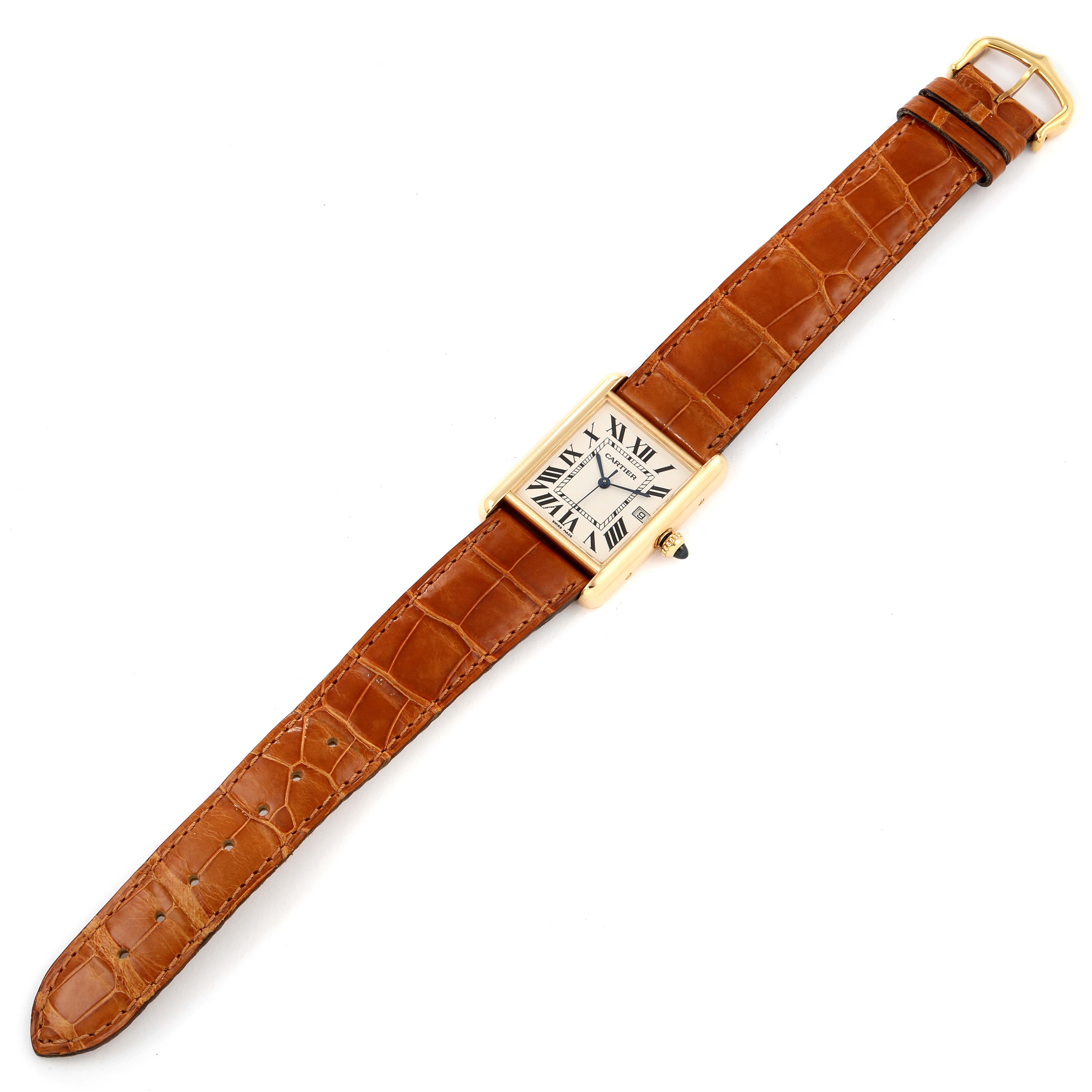 The Tank Louis model by Cartier is shown from a top-down angle, featuring its rectangular dial and brown leather strap.