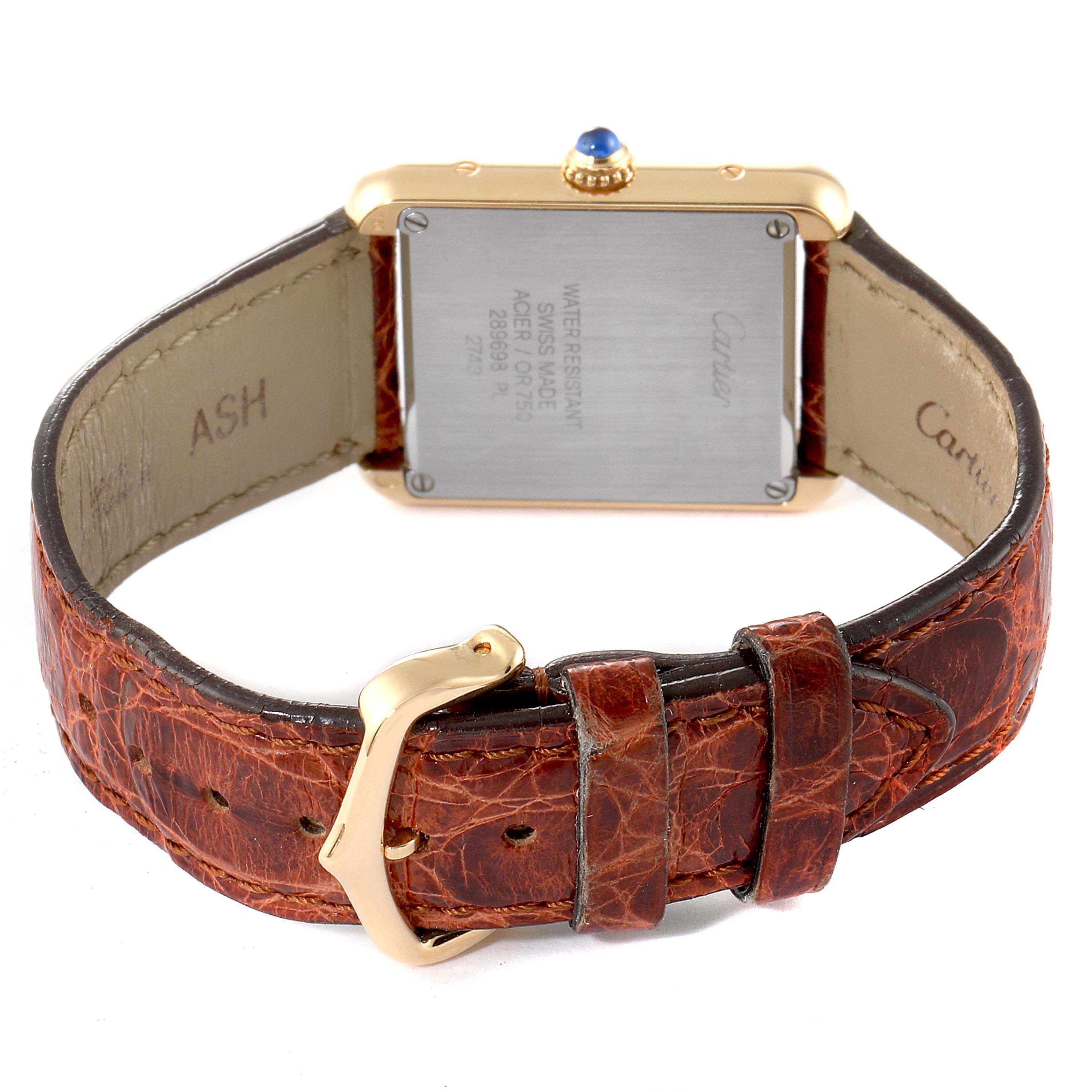 The image shows the back view of a Cartier Tank Solo W1018755 Women's Yellow Gold Silver Dial W1018755 Women's Yellow Gold Silver Dial watch, focusing on the case back and brown leather strap.