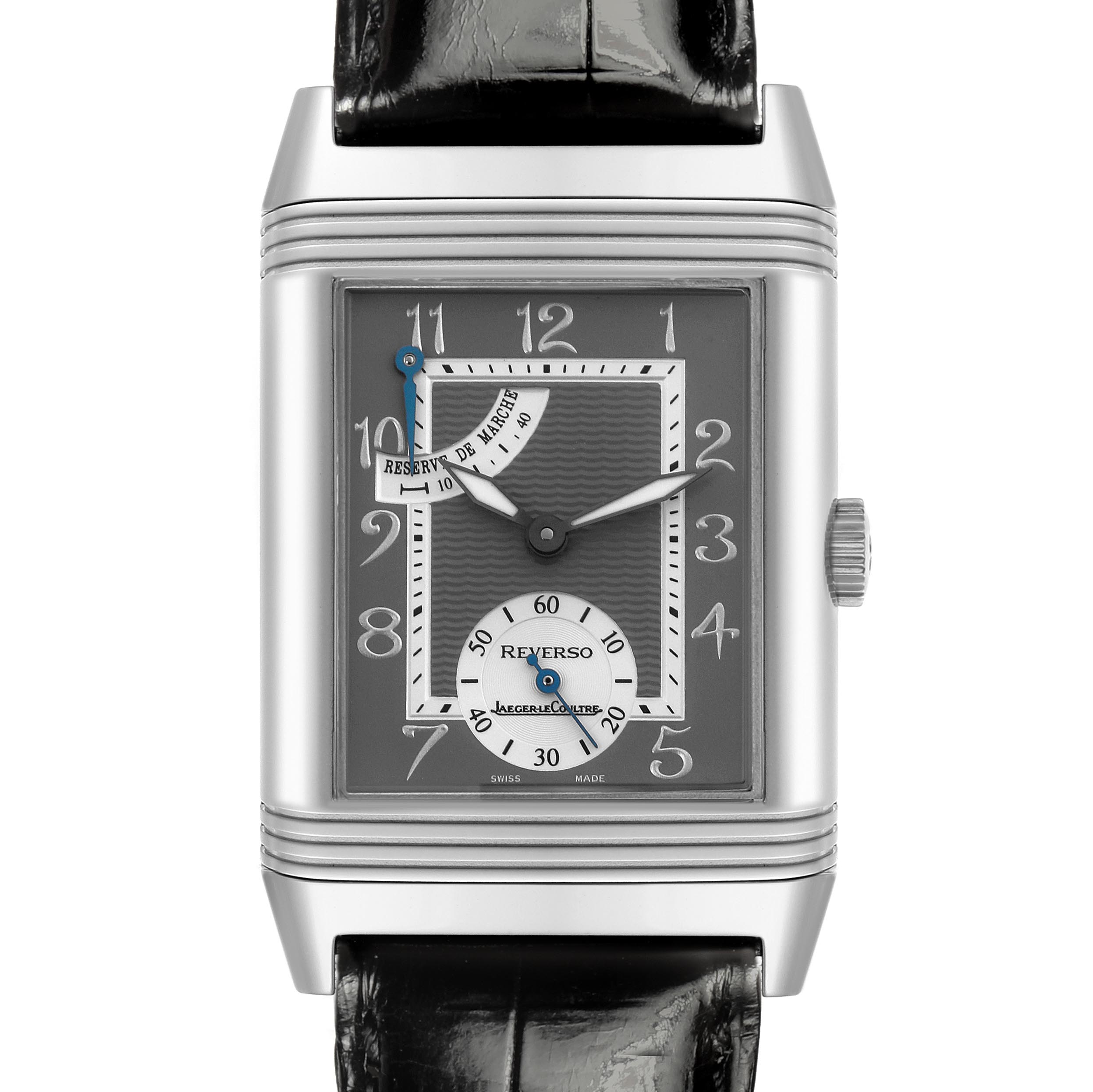 The Jaeger-LeCoultre Reverso watch is shown from a front angle, displaying the face, crown, and part of the black strap.