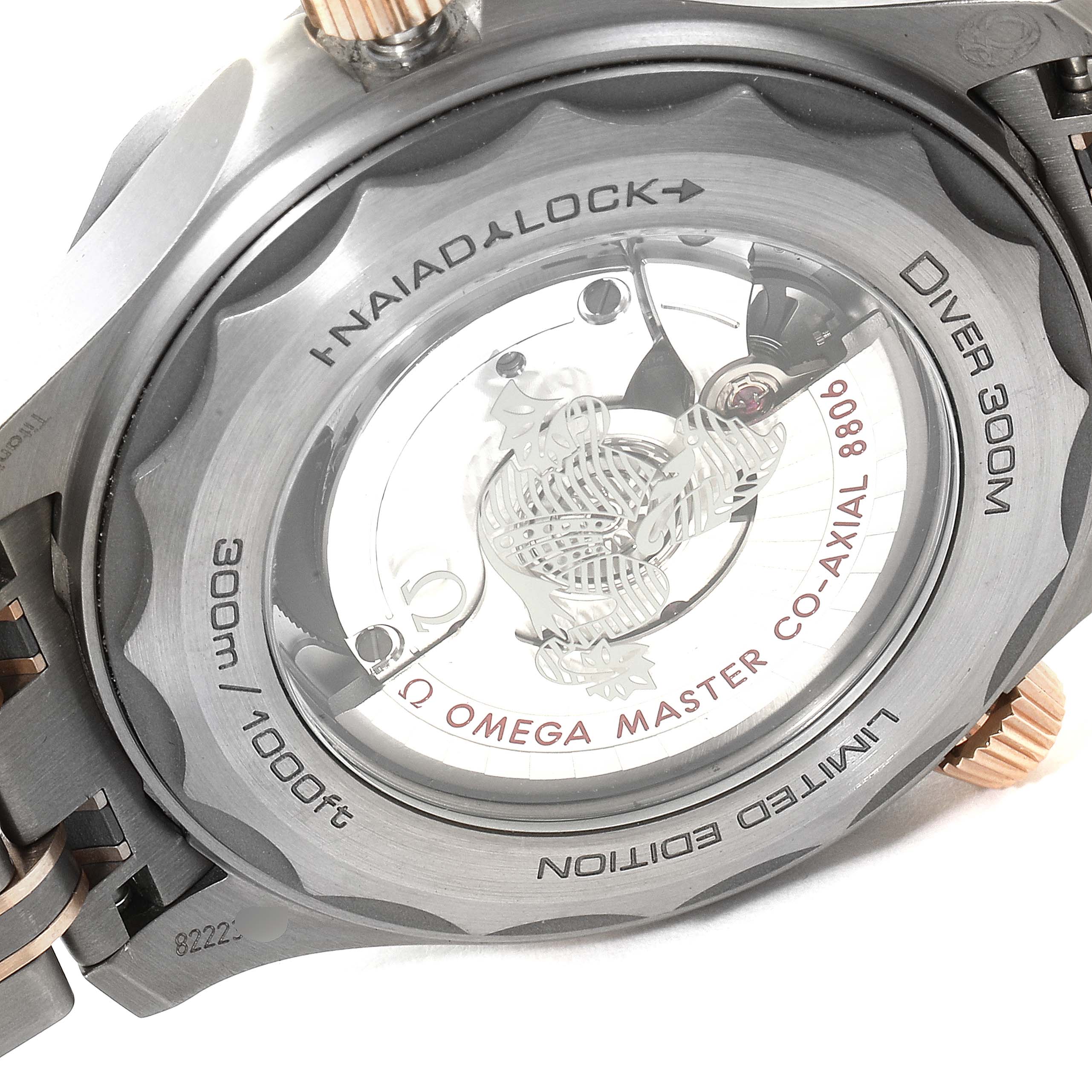 This image shows the case back of the Omega Seamaster 210.60.42.20.99.001  Men
s Titanium Grey Dial 210.60.42.20.99.001  Men
s Titanium Grey Dial Diver 300M, highlighting its Naiad Lock and Co-Axial Master Chronometer movement.