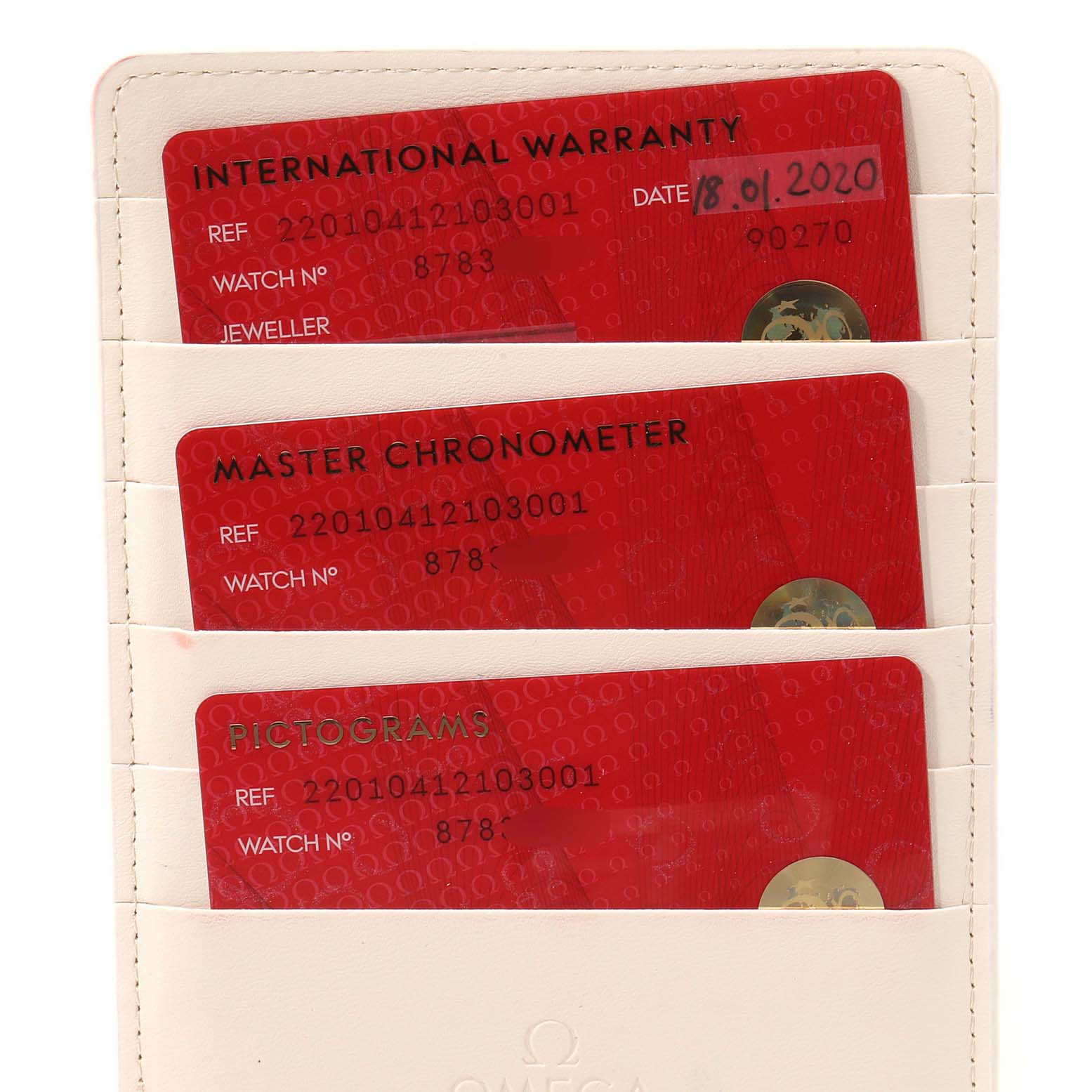 The image shows three red Omega Aqua Terra 220.10.41.21.03.001 Men's Stainless Steel Blue Dial 220.10.41.21.03.001 Men's Stainless Steel Blue Dial model cards: international warranty, master chronometer, and pictograms, in a holder.