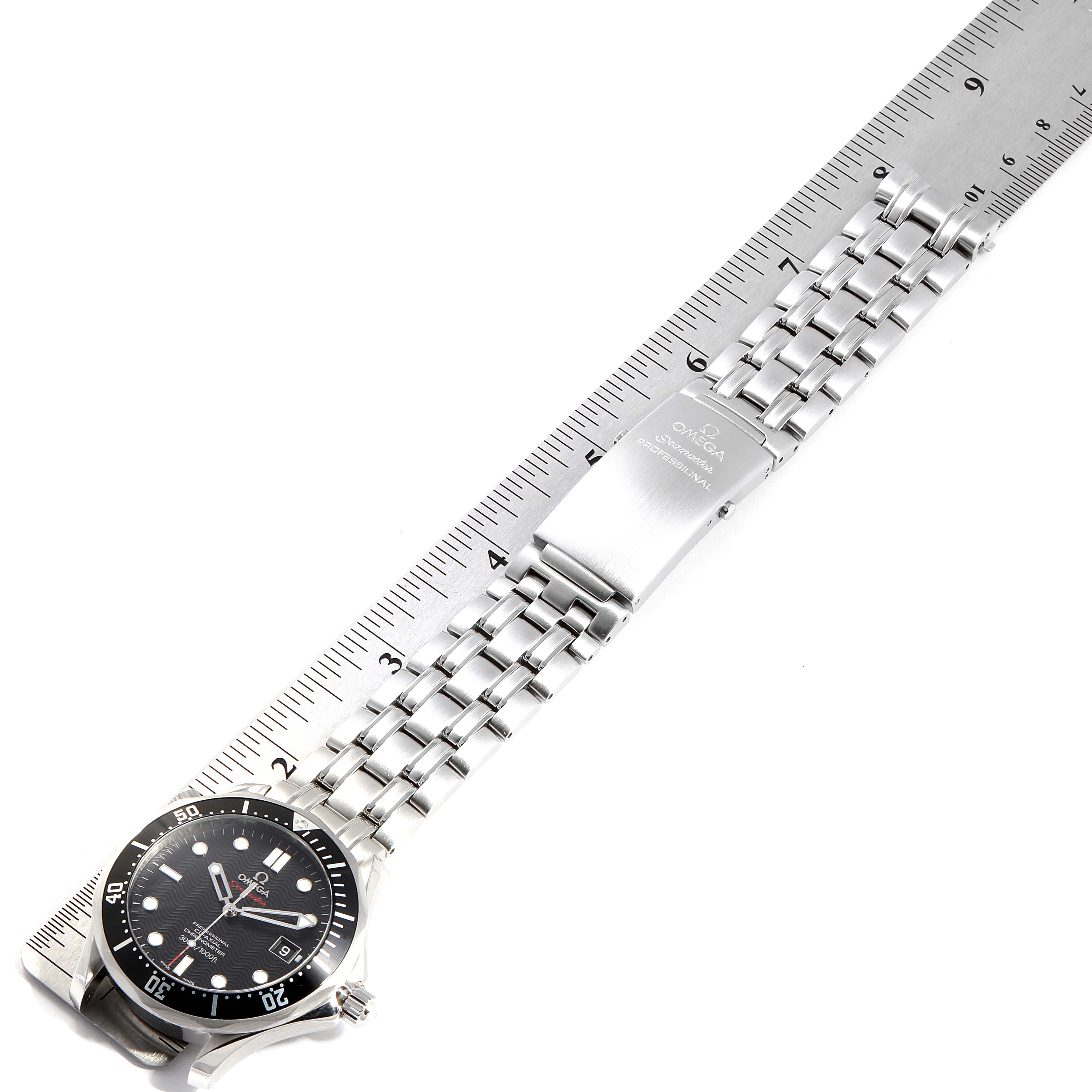 The image shows a top-down view of an Omega Seamaster 212.30.41.20.01.002 Men
s Stainless Steel Black Dial 212.30.41.20.01.002 Men
s Stainless Steel Black Dial watch, focusing on the dial, band, and clasp next to a ruler.