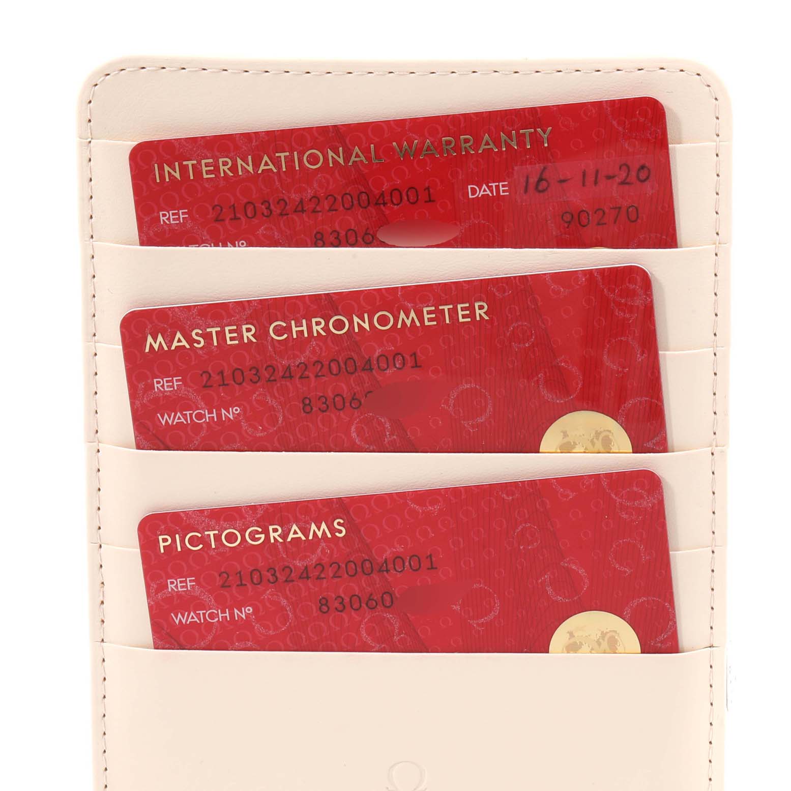 The image shows the international warranty, master chronometer, and pictograms cards for an Omega Seamaster 210.32.42.20.04.001 Men
s Stainless Steel White Dial 210.32.42.20.04.001 Men
s Stainless Steel White Dial watch in a cardholder.