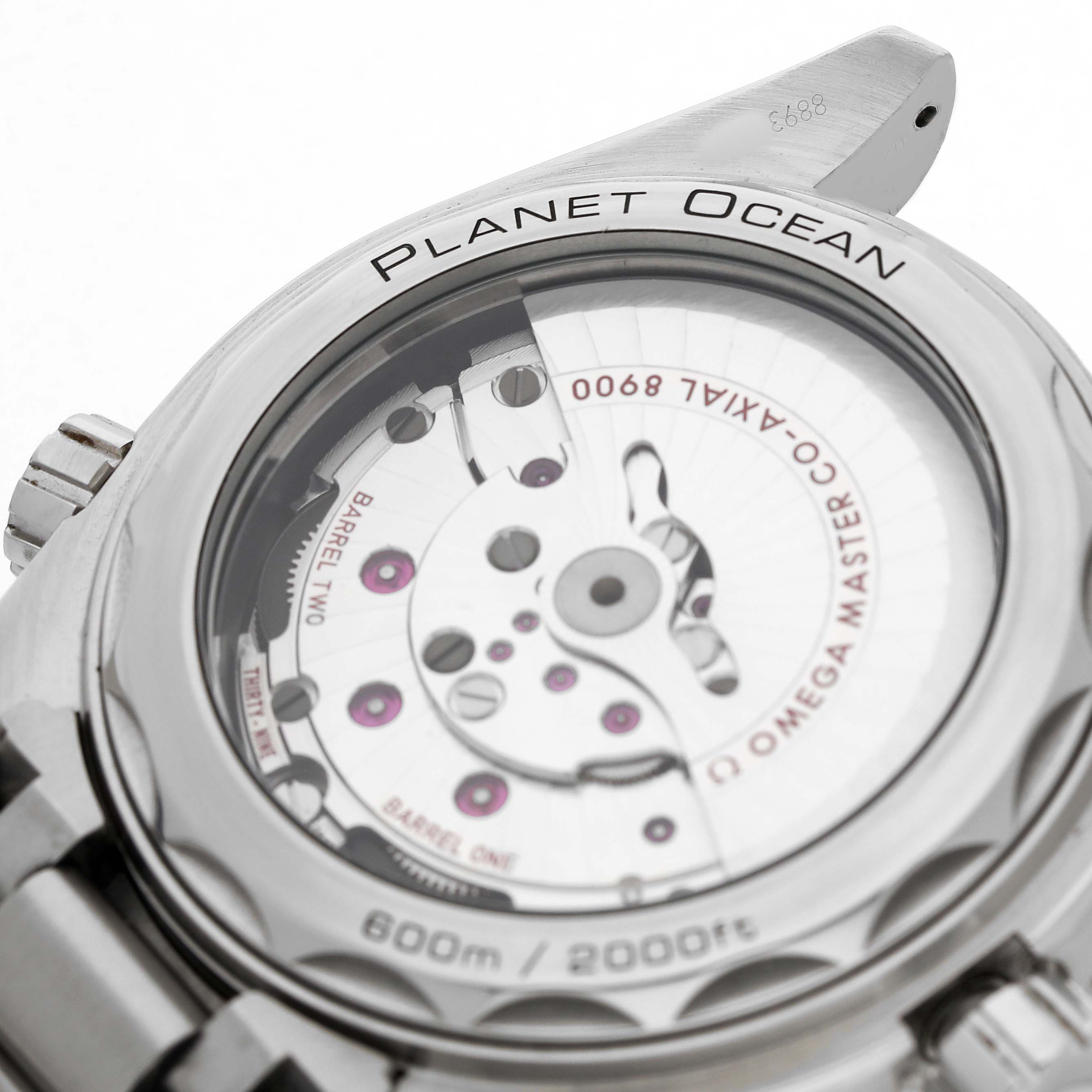 The image shows the back view of the Omega Planet Ocean 215.30.44.21.03.001 Men's Stainless Steel Blue Dial model, highlighting its exposed movement and case details.