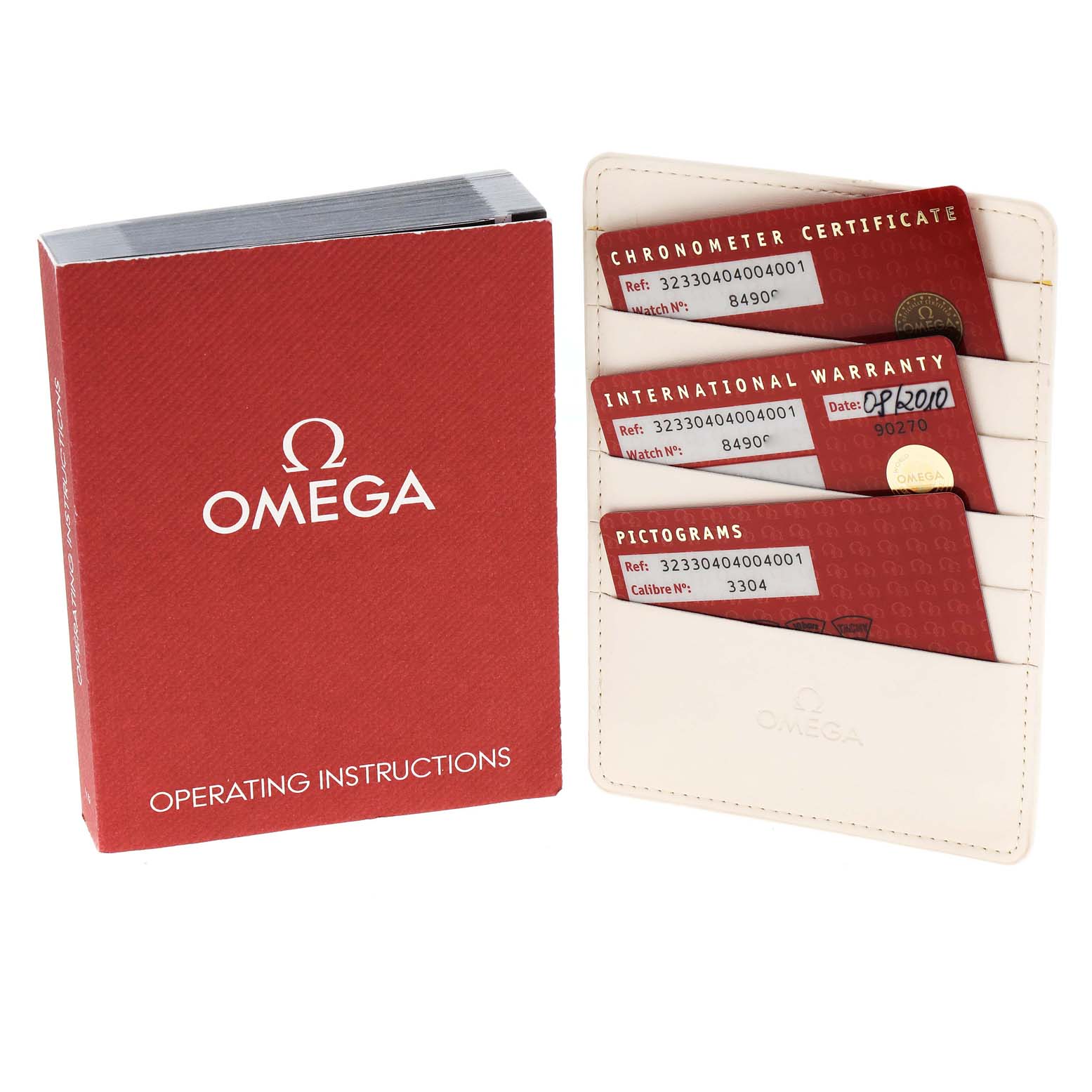 The image shows a red Omega Speedmaster 323.30.40.40.04.001 Men's Stainless Steel White Dial 323.30.40.40.04.001 Men's Stainless Steel White Dial operating instructions book and a cardholder with three certification cards.