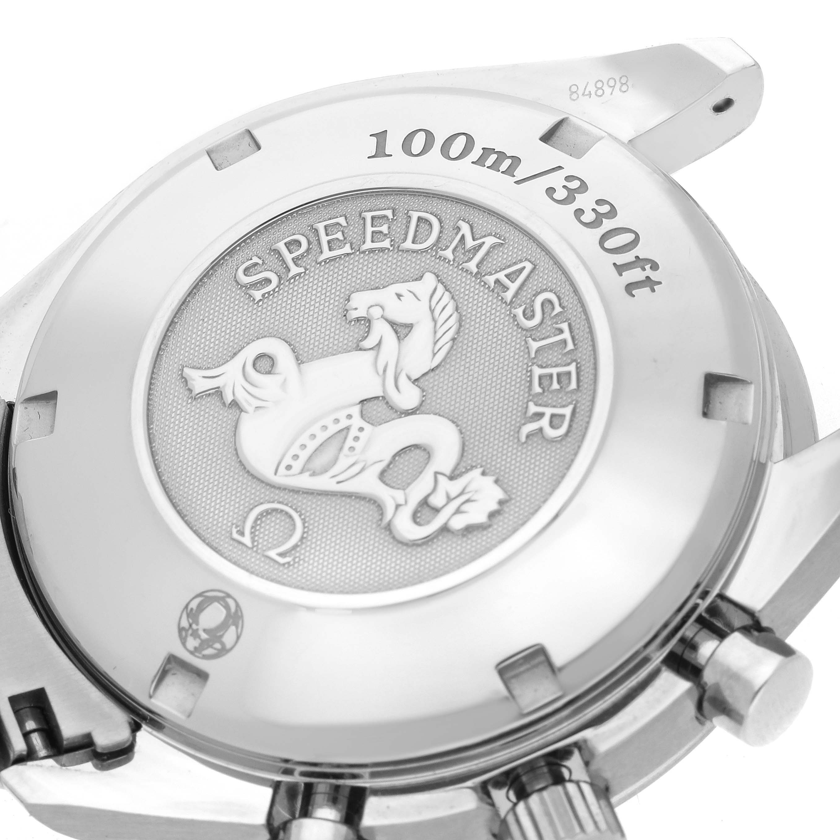 The image shows the back case of an Omega Speedmaster 323.10.40.40.02.001 Men
s Stainless Steel Silver Dial 323.10.40.40.02.001 Men
s Stainless Steel Silver Dial, highlighting the engraved emblem and 100m/330ft water resistance marking.