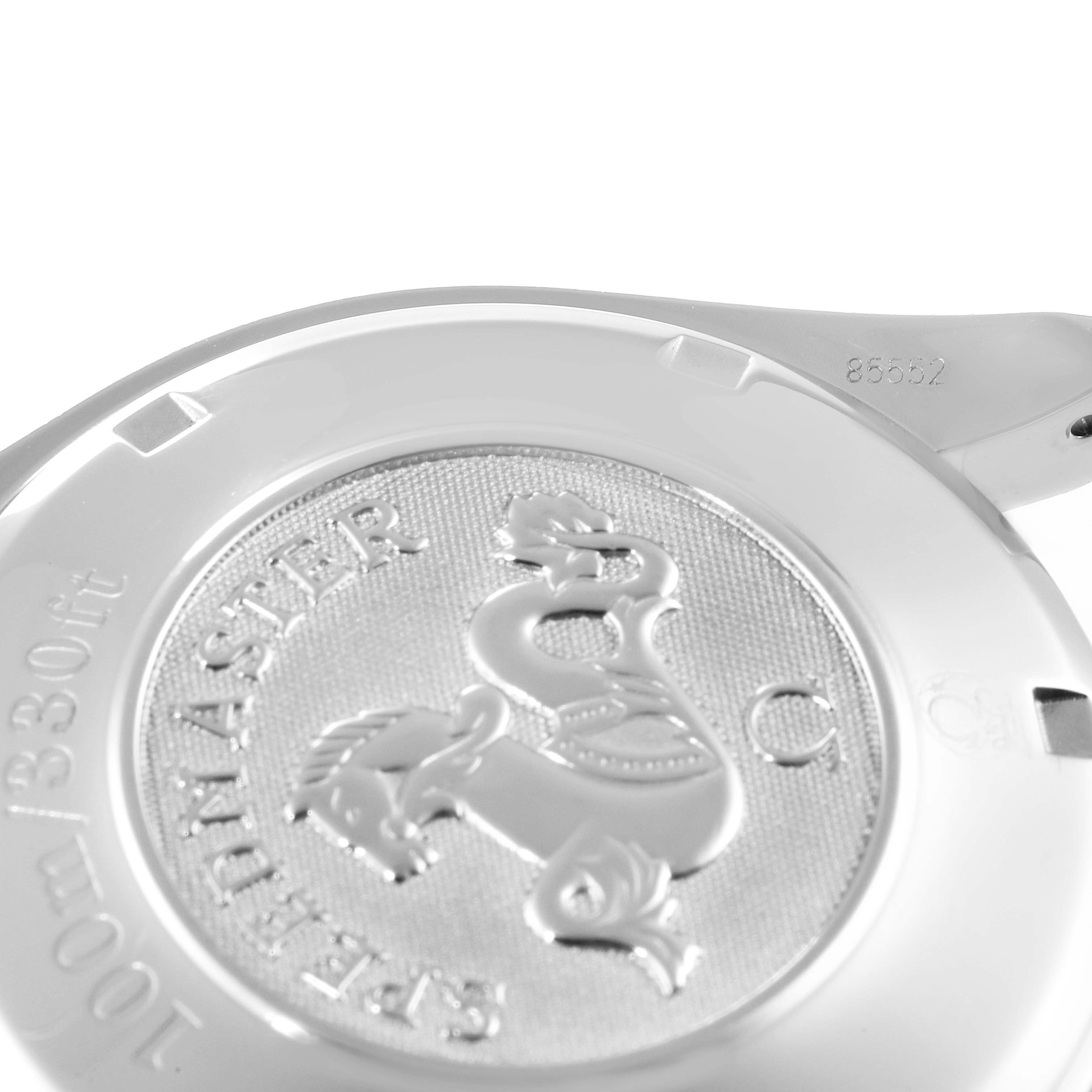 This image shows the backside and partial casing of an Omega Speedmaster 3211.31.00 Men
s Stainless Steel Silver Dial 3211.31.00 Men
s Stainless Steel Silver Dial watch, featuring engraved details and a logo.