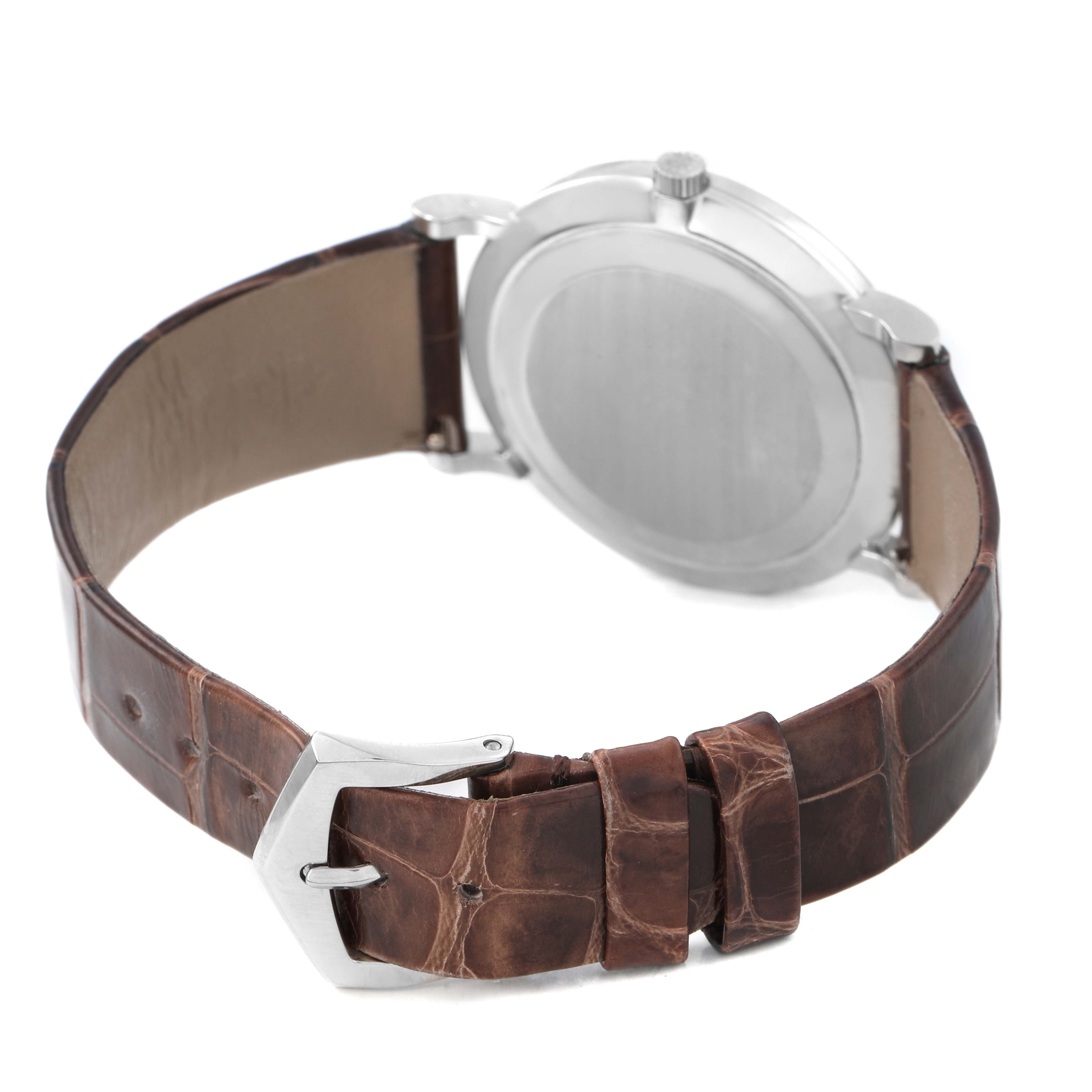 The image shows the back of a Patek Philippe Calatrava 5022P-012 Men's Platinum White Dial watch, focusing on the case back and brown leather strap with a buckle.