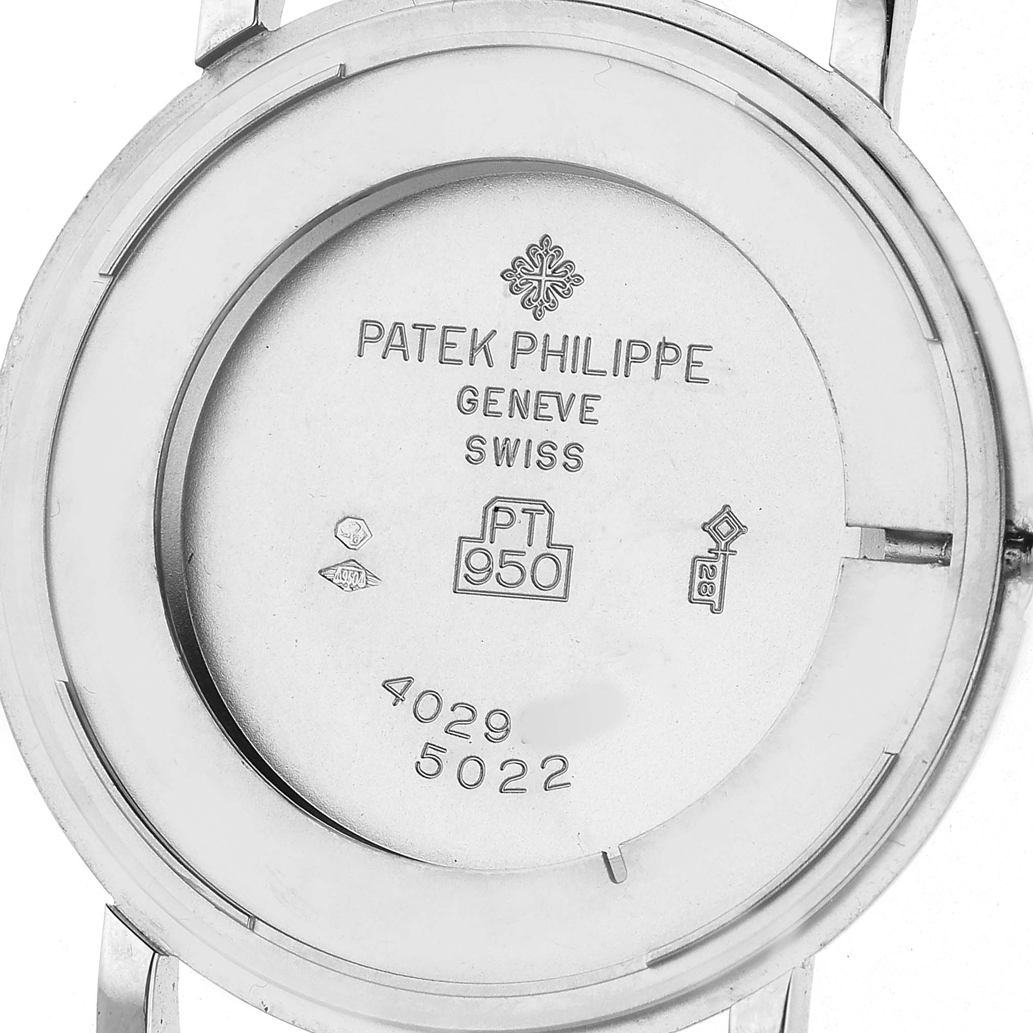 The image shows the back case of a Patek Philippe Calatrava 5022P-012 Men's Platinum White Dial watch, highlighting engravings and hallmarks.