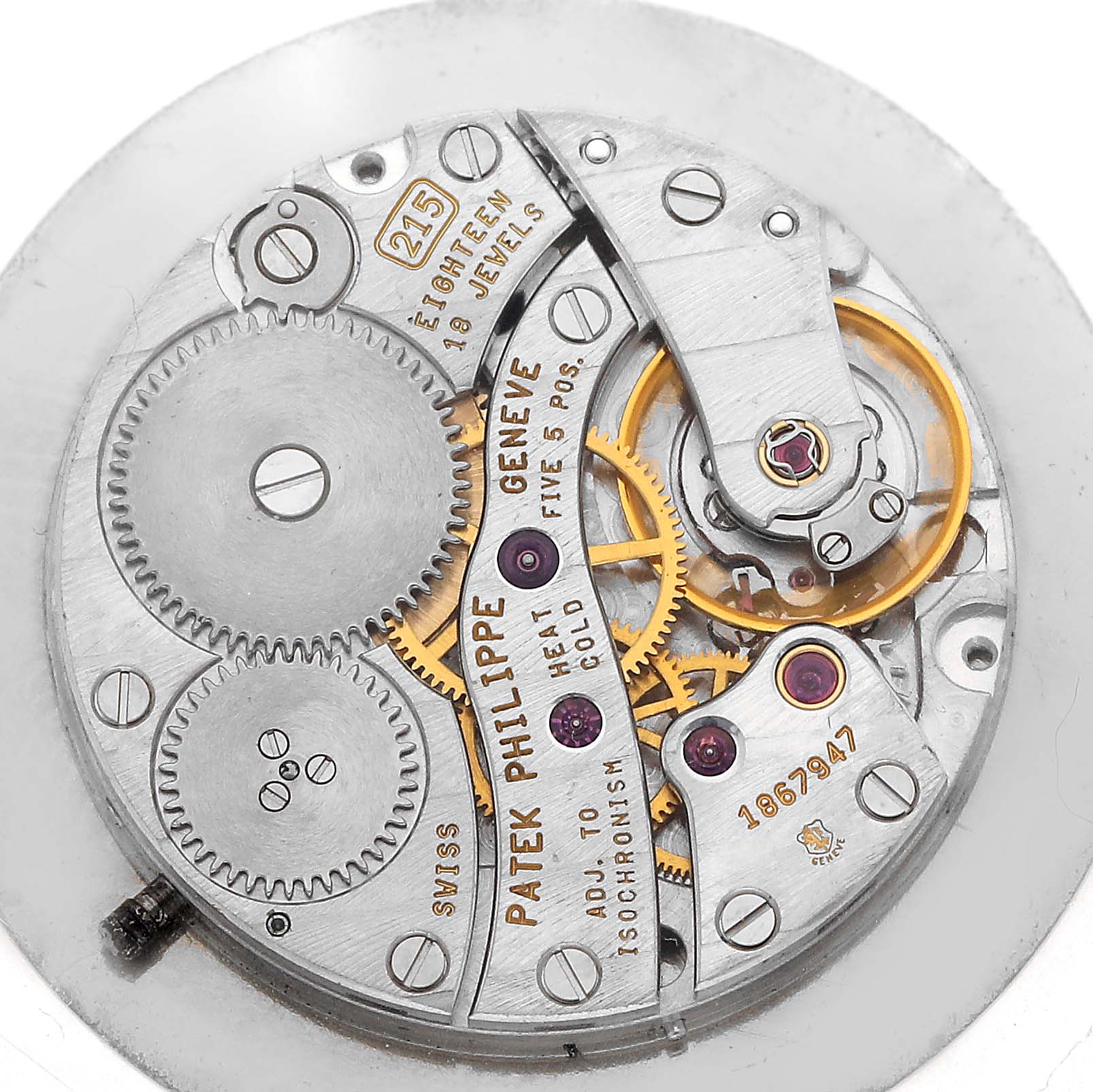 The image shows a close-up of the movement mechanism of a Patek Philippe Calatrava 5022P-012 Men's Platinum White Dial watch, highlighting gears and jewels.
