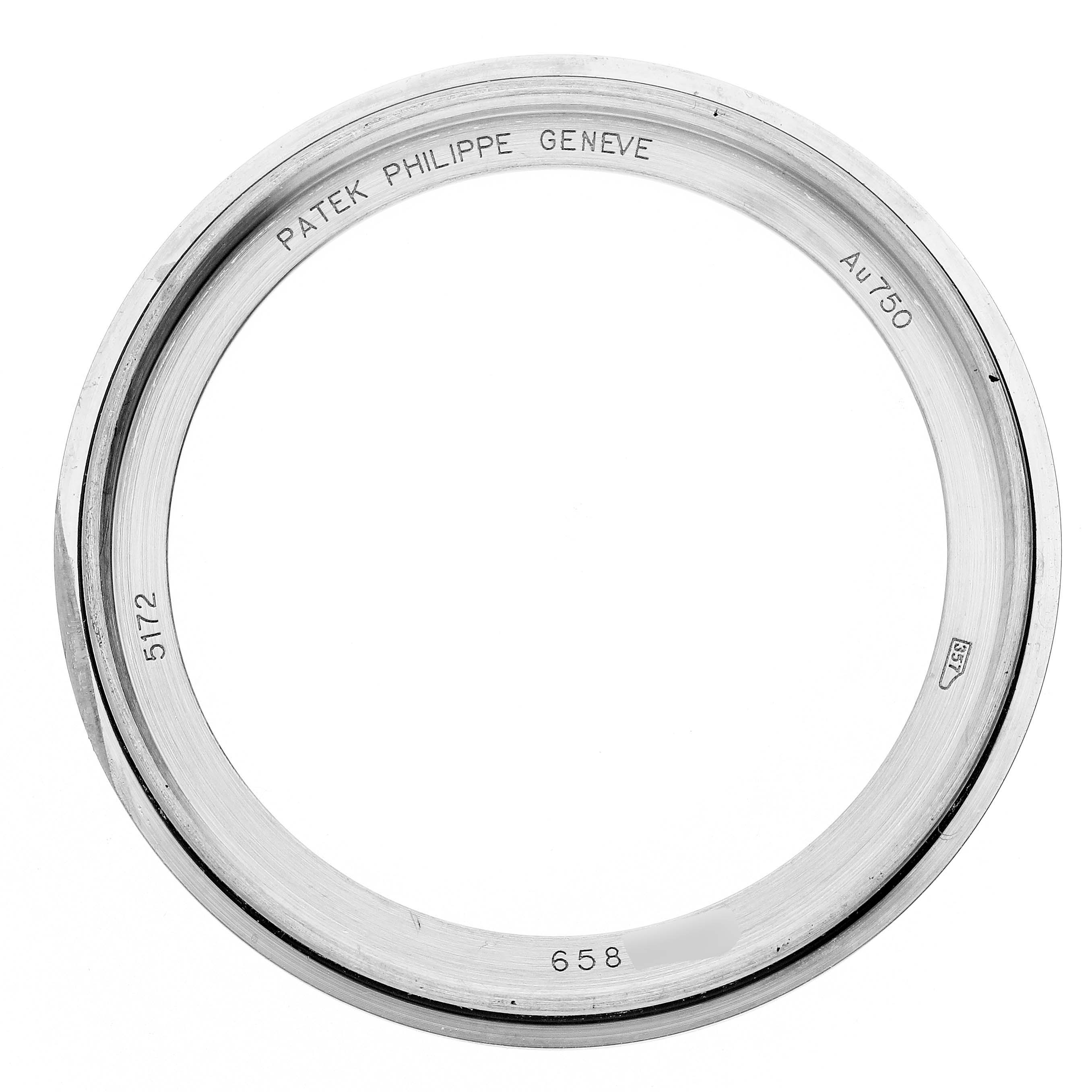 The image shows the bezel of a Patek Philippe Complications 5172G-001 Men's White Gold Orange Dial watch from a top view, detailing engravings and hallmarks.
