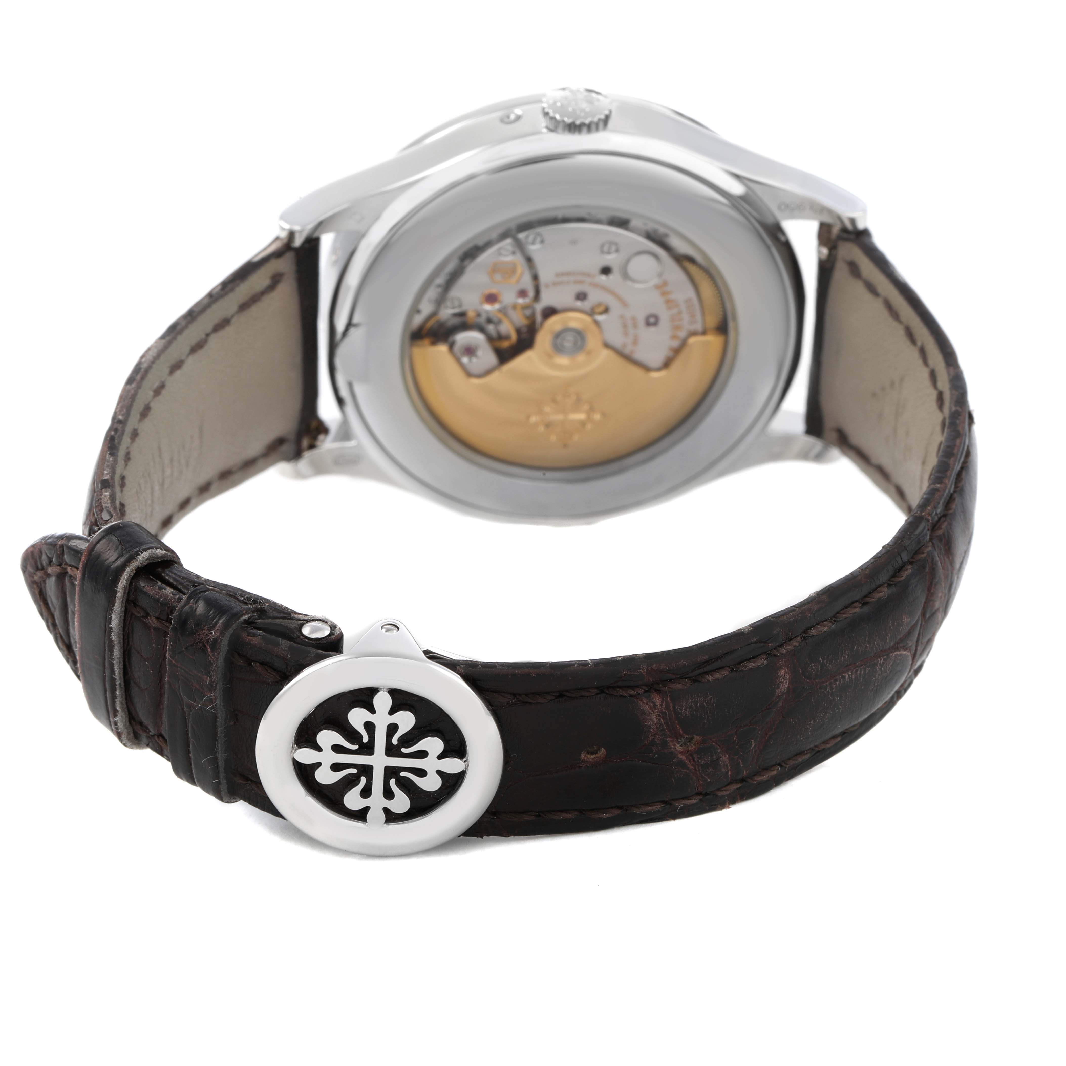 The image shows the back view of a Patek Philippe Complications 5496P Men's Platinum Silver Dial watch, highlighting the movement and leather strap.
