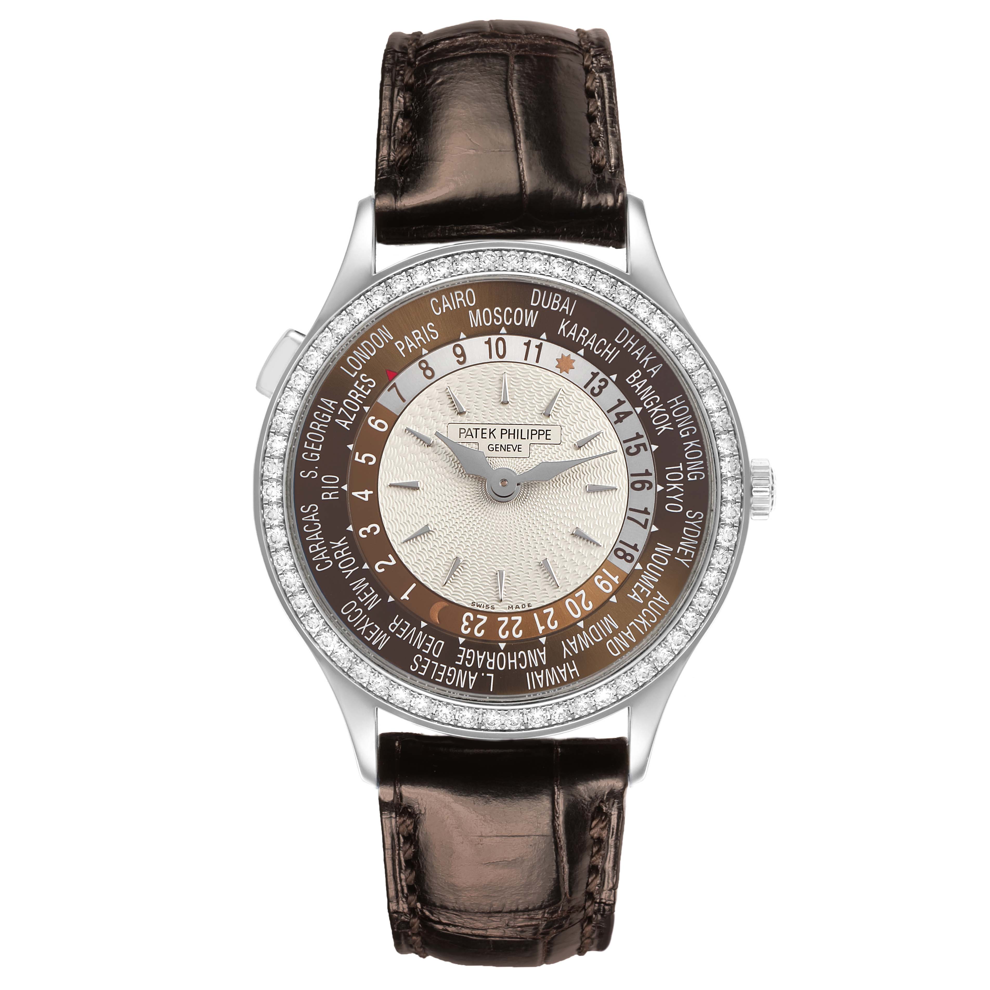 The image shows a Patek Philippe Complications 7130G Men's White Gold Brown Dial watch from a straight-on angle, highlighting its world time dial and leather strap.