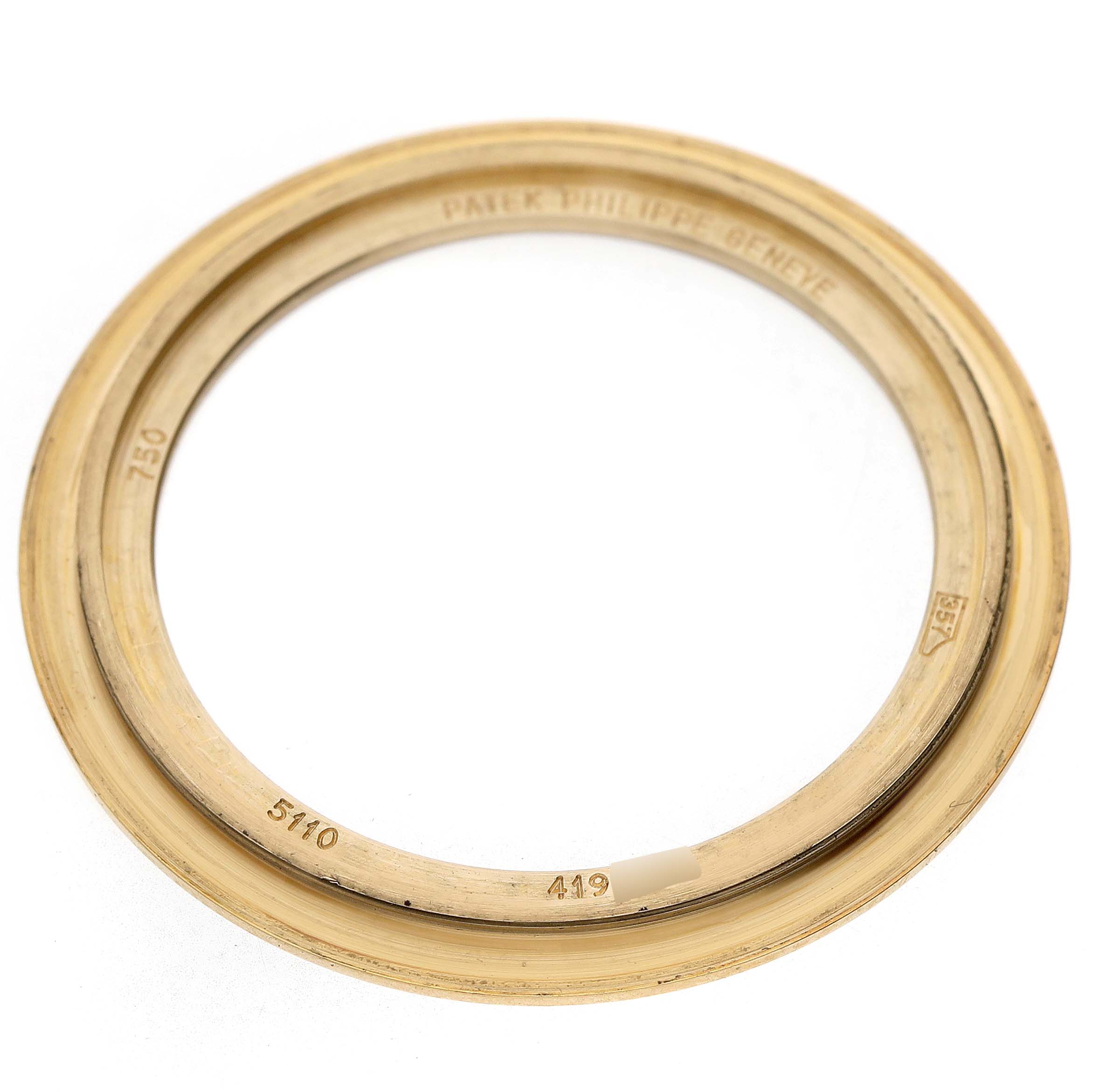 The image shows a top view of a gold bezel for the Patek Philippe Complications 5110J Men's Yellow Gold Silver Dial model, inscribed with "PATEK PHILIPPE GENEVE."