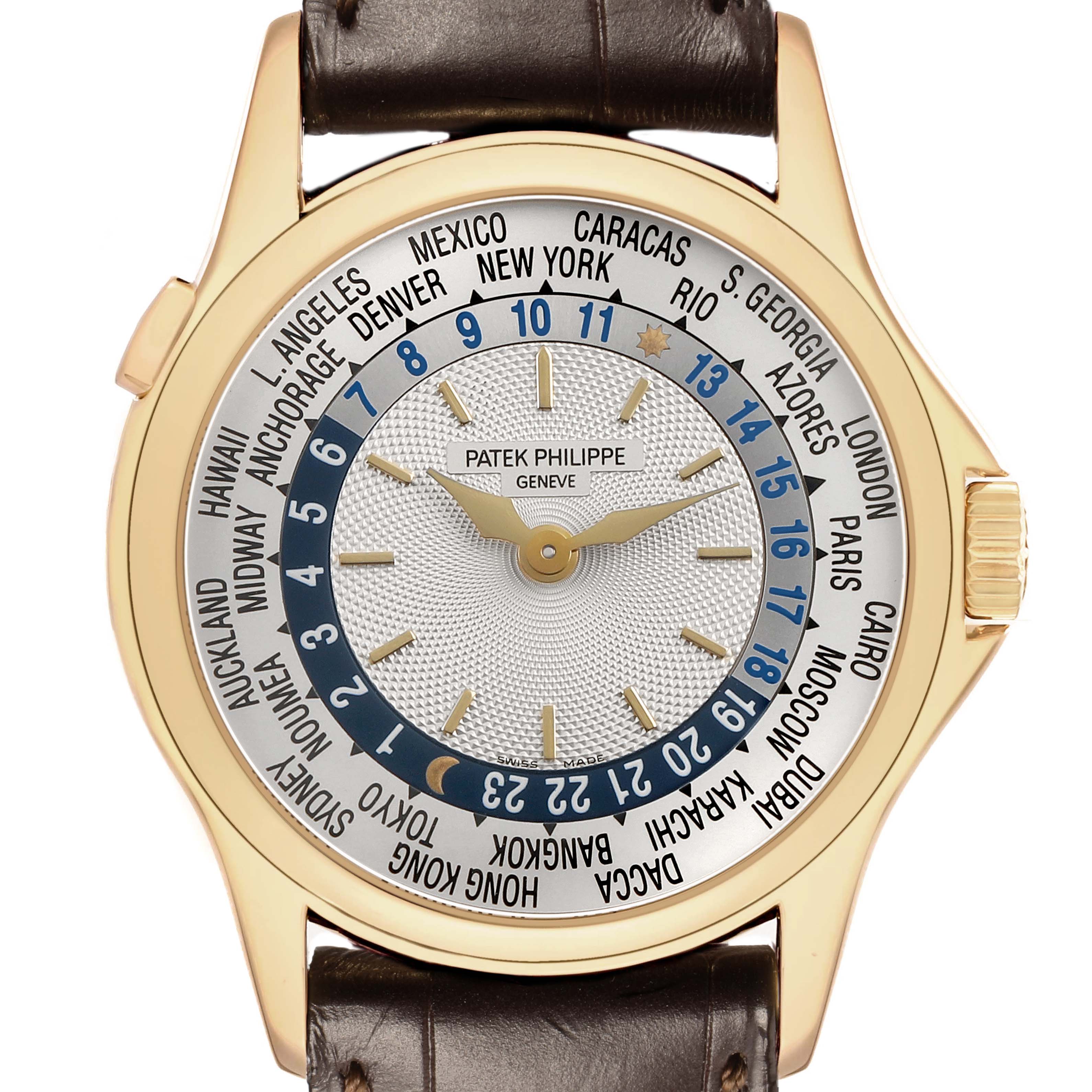 The Patek Philippe Complications 5110J Men's Yellow Gold Silver Dial watch is shown from a top view, featuring a detailed world time dial and leather strap.