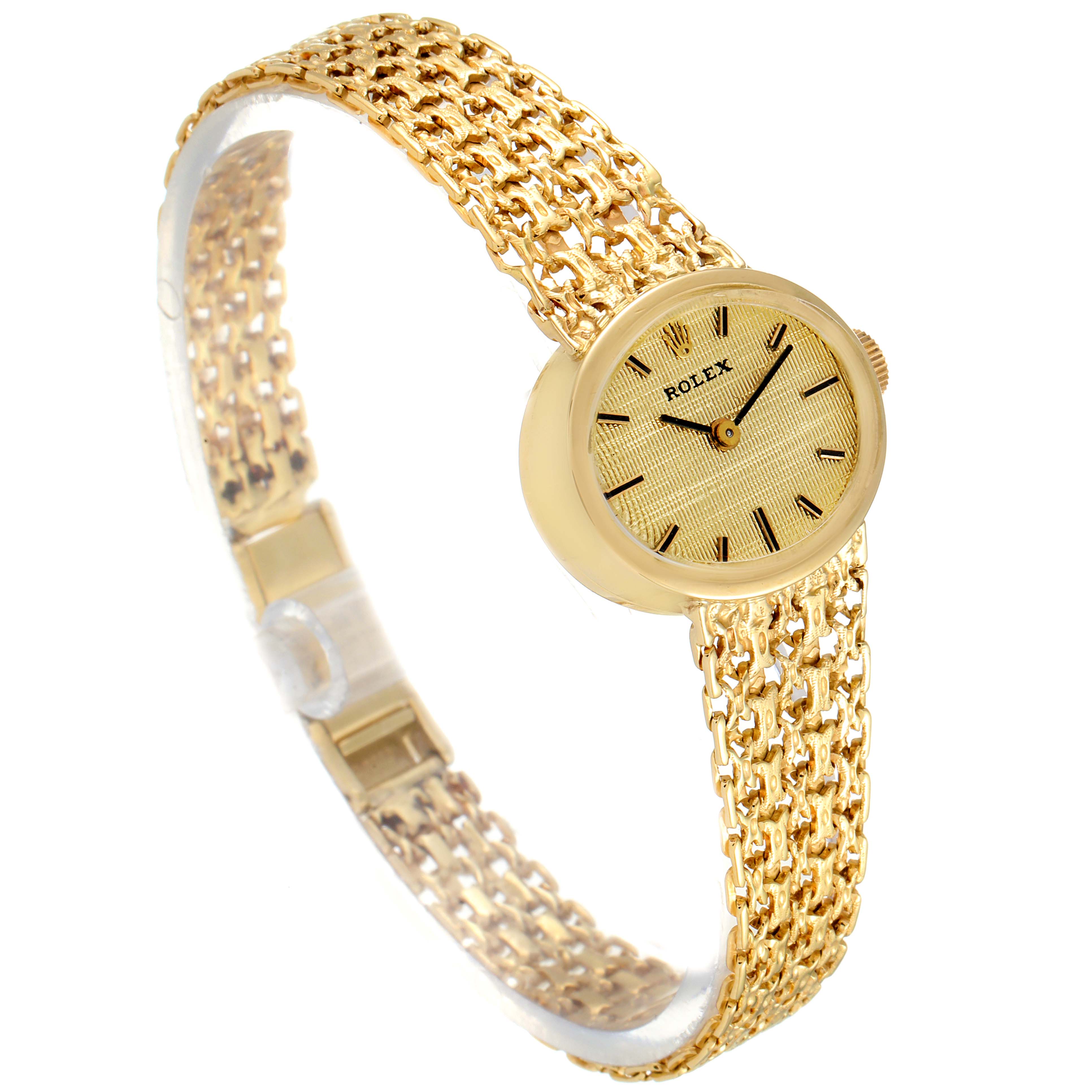 The image shows a Rolex Cocktail Women's Yellow Gold Champagne Dial Women's Yellow Gold Champagne Dial model watch from an angle highlighting its gold mesh bracelet and round dial.