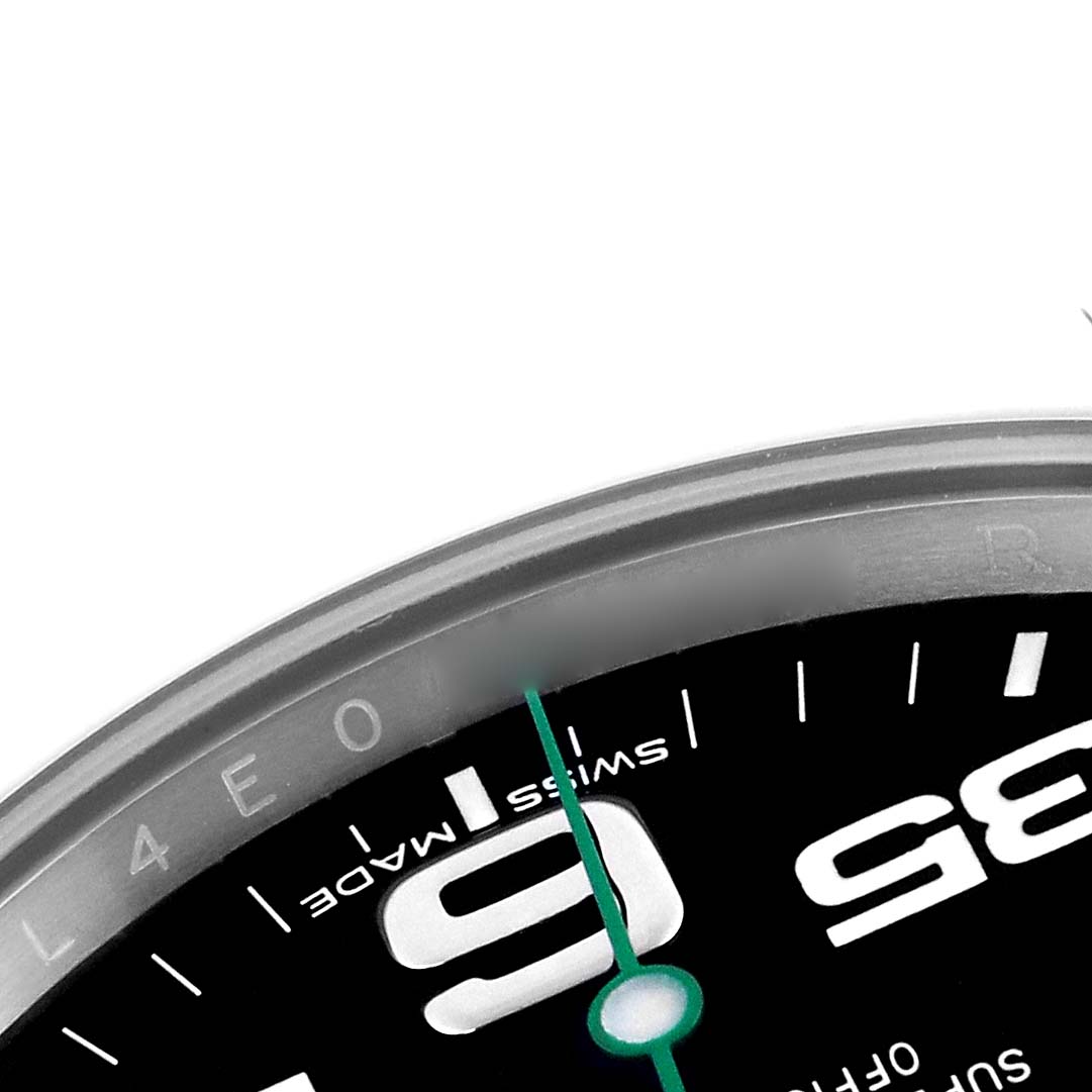 The image shows a close-up of the Rolex Air-King 116900 Men
s Stainless Steel Black Dial 116900 Men
s Stainless Steel Black Dial watch face, highlighting the numeral "9" and part of the green second hand.