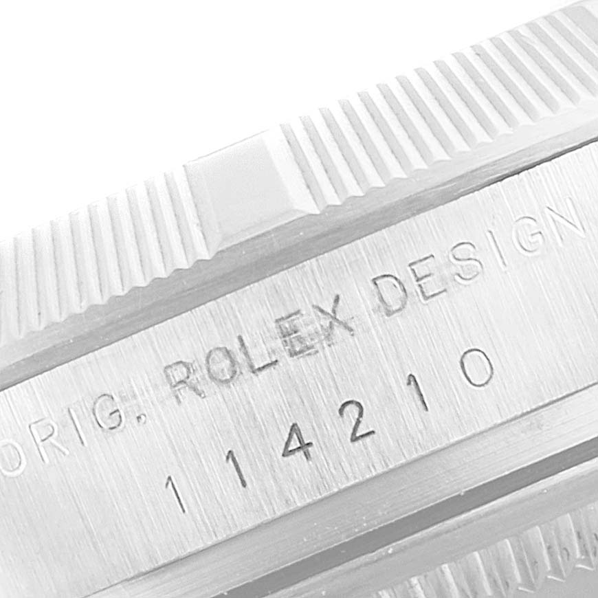 This close-up image shows the engraved reference number and designer details on the case of a Rolex Air-King 114210 Men's Stainless Steel Silver Dial 114210 Men's Stainless Steel Silver Dial watch.