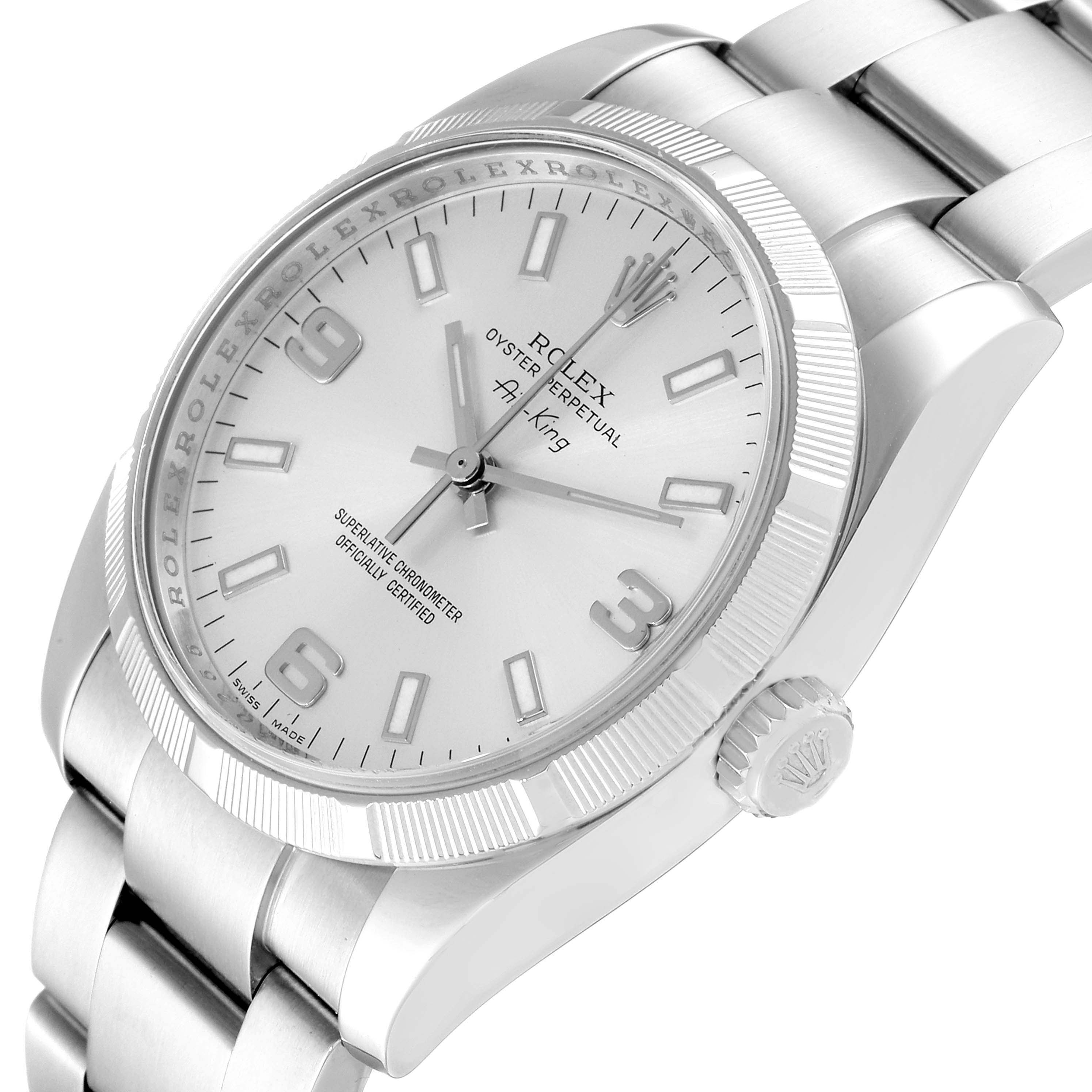 The Rolex Air-King 114210 Men's Stainless Steel Silver Dial 114210 Men's Stainless Steel Silver Dial watch is shown at an angled side view, featuring the dial, crown, and part of the bracelet.