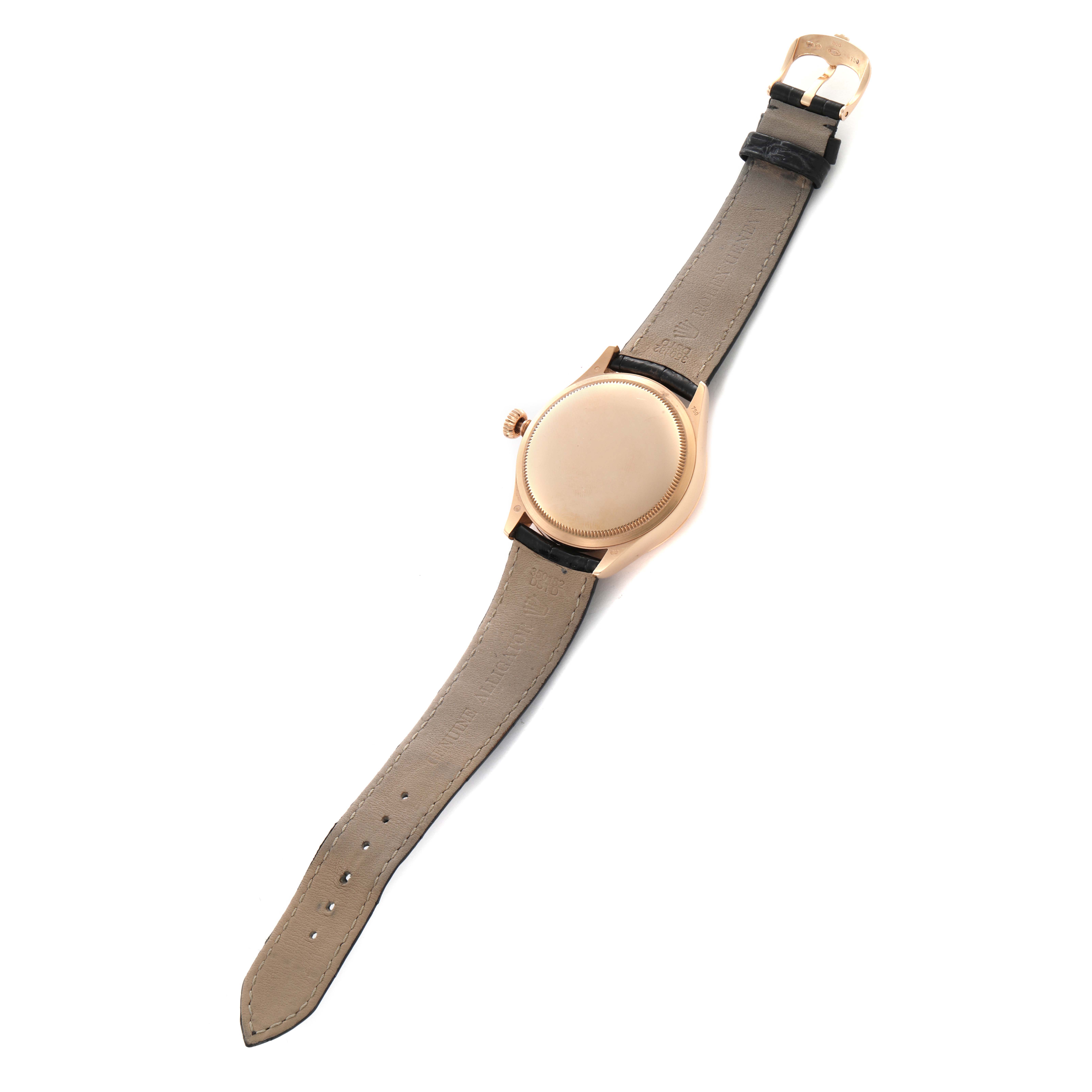 The Rolex Cellini 50525 Men
s Rose Gold Black Dial 50525 Men
s Rose Gold Black Dial watch is shown from the back, displaying the case back, strap, and buckle.