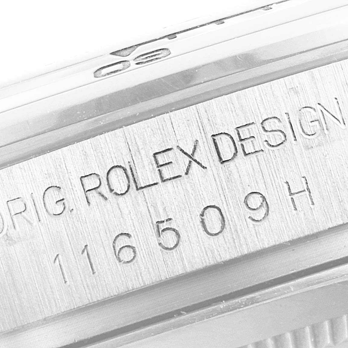 A close-up view of the case edge of a Rolex Daytona 116509 Men's White Gold Blue Dial 116509 Men's White Gold Blue Dial watch, showing the model number and "Rolex Design" engraving.