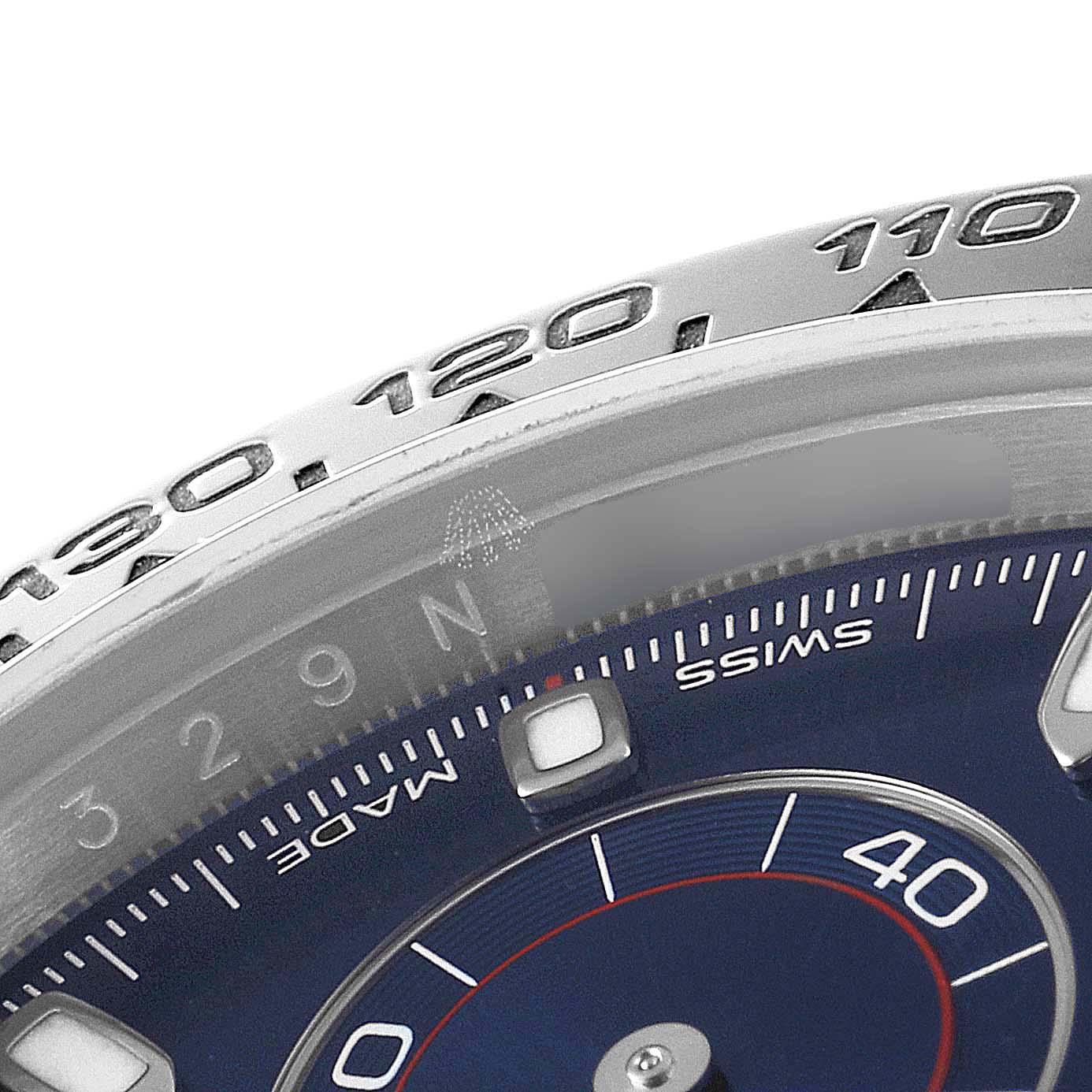 This close-up image shows part of the bezel and dial of a Rolex Daytona 116509 Men's White Gold Blue Dial 116509 Men's White Gold Blue Dial watch, including the tachymeter scale and minute markers.