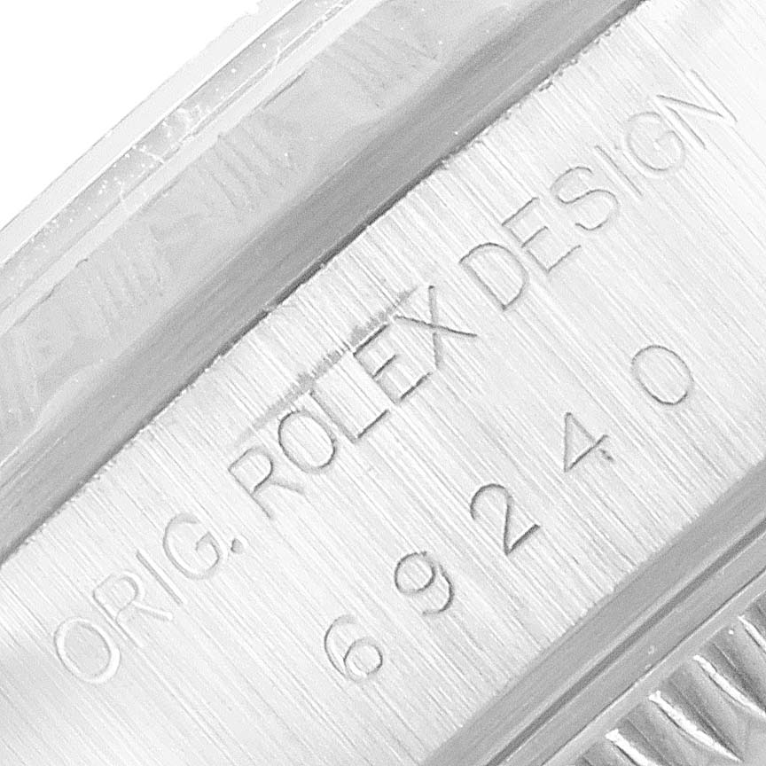 This close-up image shows the side of the case with the engraving "ORIG. ROLEX DESIGN 69240" of a Date model Rolex watch.