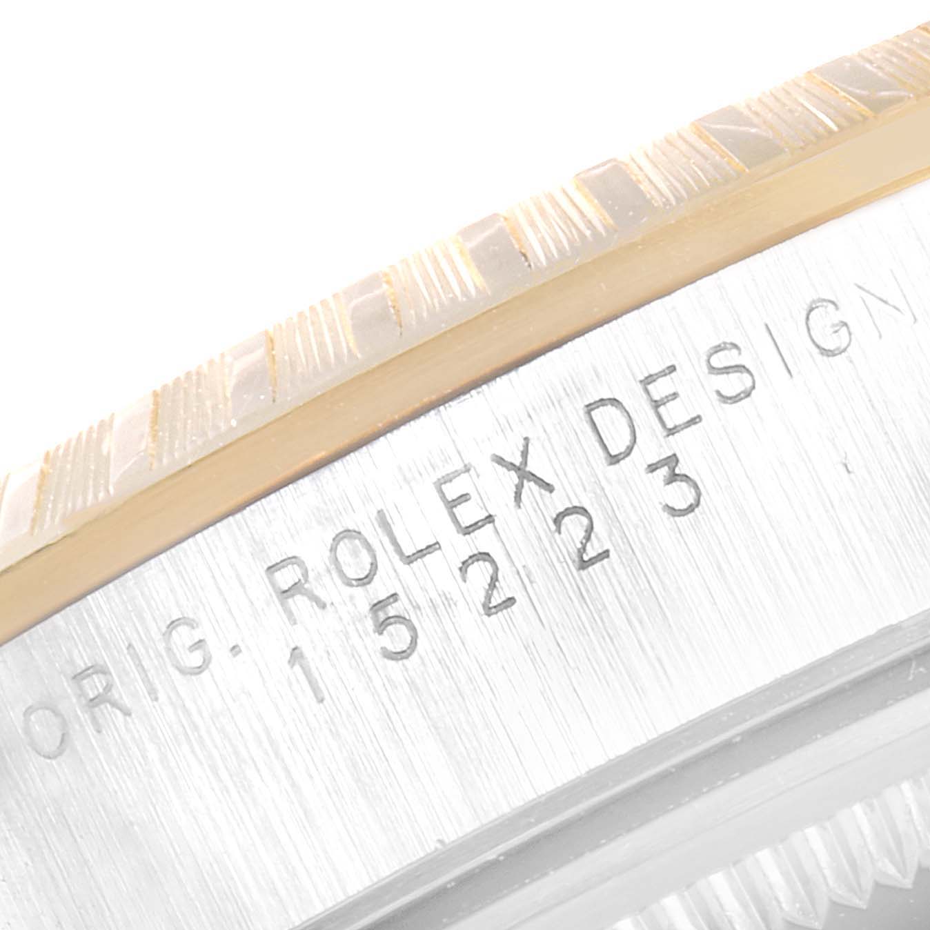 The image shows a close-up of the case edge and engraved details of a Rolex Date 15223 Men's Steel and Gold (two tone) Silver Dial 15223 Men's Steel and Gold (two tone) Silver Dial model watch.