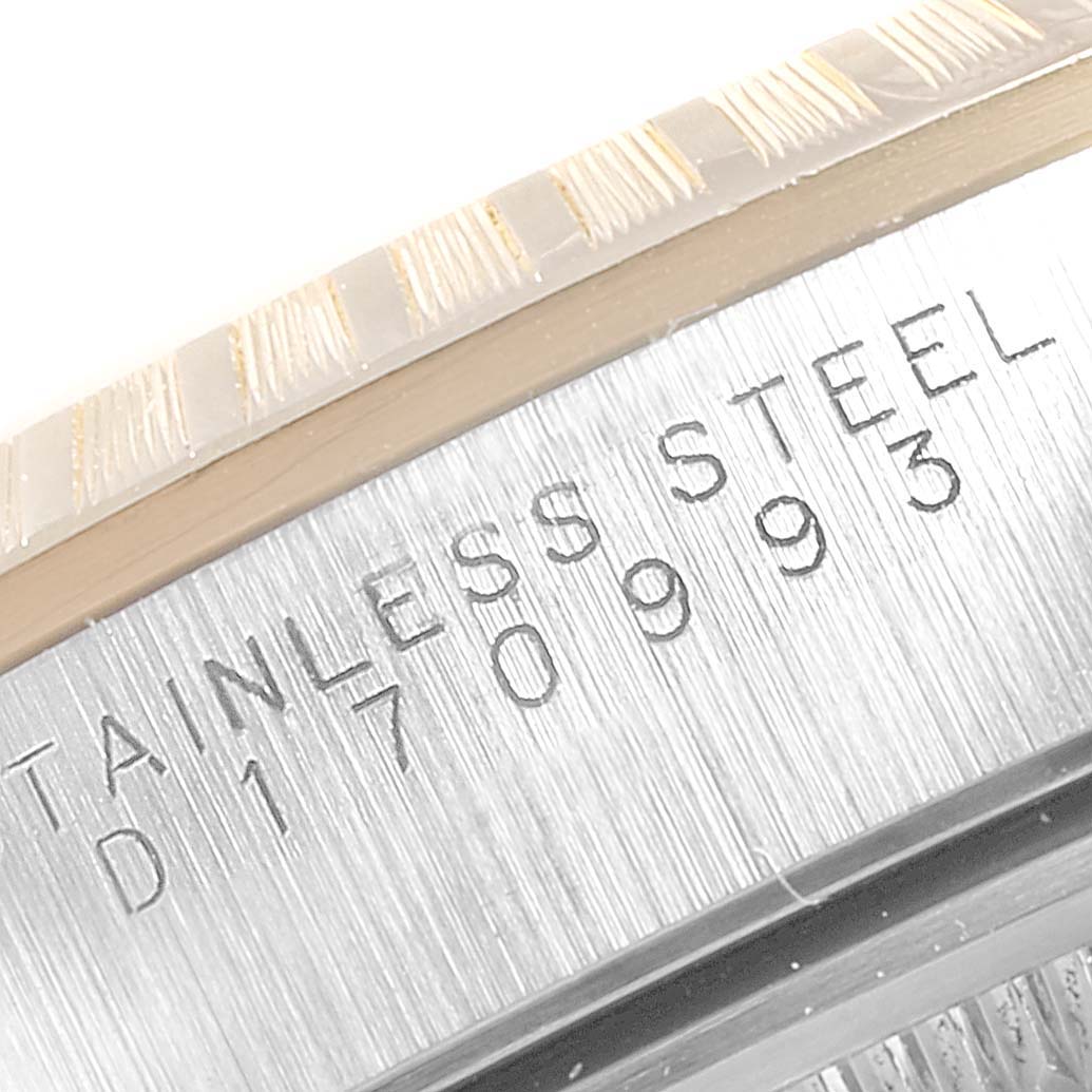 The image shows a close-up of the case with engraved serial numbers for a Rolex Date 15223 Men's Steel and Gold (two tone) Silver Dial 15223 Men's Steel and Gold (two tone) Silver Dial model watch.
