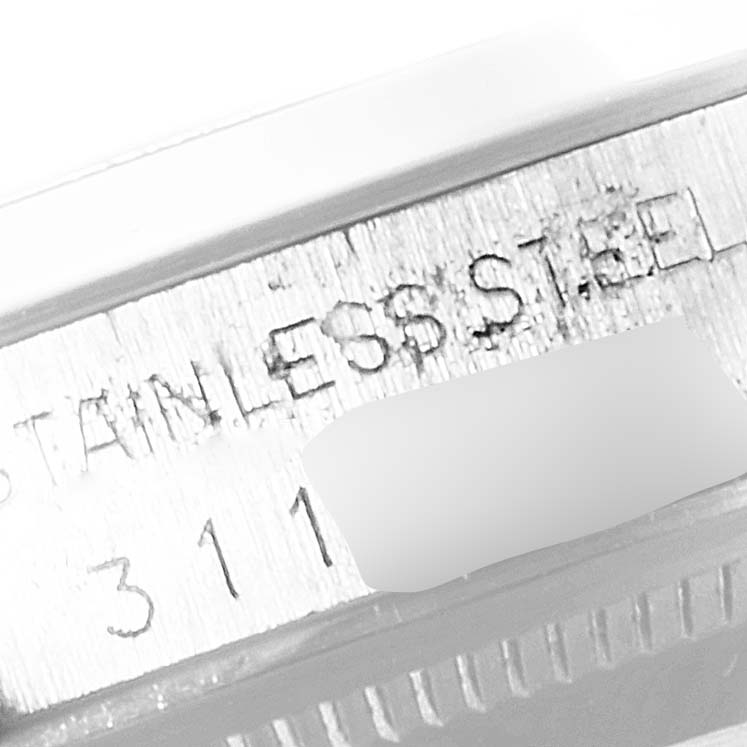 This close-up angle shows part of the casing and inscription of a Rolex Date 1500 Men's Stainless Steel Silver Dial 1500 Men's Stainless Steel Silver Dial model watch, highlighting the "STAINLESS STEEL" text.