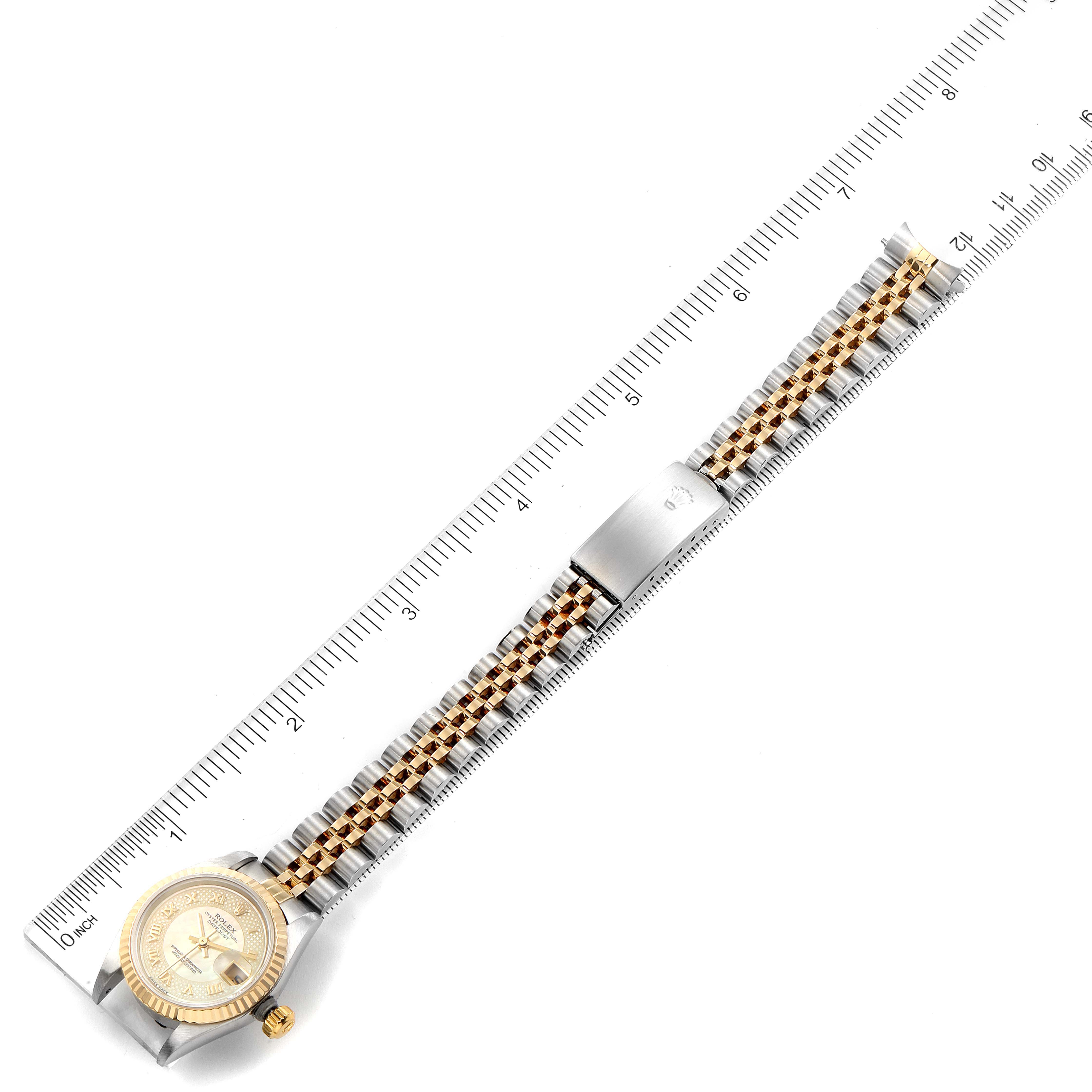 The image shows a Rolex Datejust 79173 Women's Steel and Gold (two tone) Mother of Pearl Dial 79173 Women's Steel and Gold (two tone) Mother of Pearl Dial watch laid flat with its full bracelet and case visible, aligned next to a ruler.