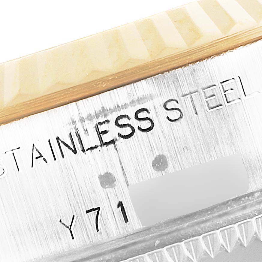 This close-up image of the Rolex Datejust 79173 Women's Steel and Gold (two tone) Mother of Pearl Dial 79173 Women's Steel and Gold (two tone) Mother of Pearl Dial shows the bezel and part of the case with "STAINLESS STEEL Y71" engraving.