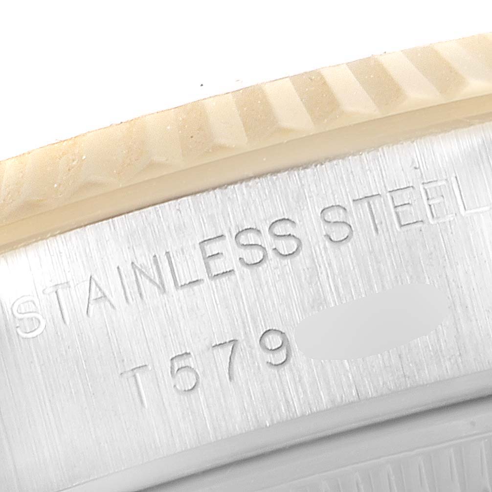 This close-up image shows the side engraving on the bezel and casing of a Rolex Datejust 69173 Women's Steel and Gold (two tone) Champagne Dial 69173 Women's Steel and Gold (two tone) Champagne Dial watch, highlighting "STAINLESS STEEL."